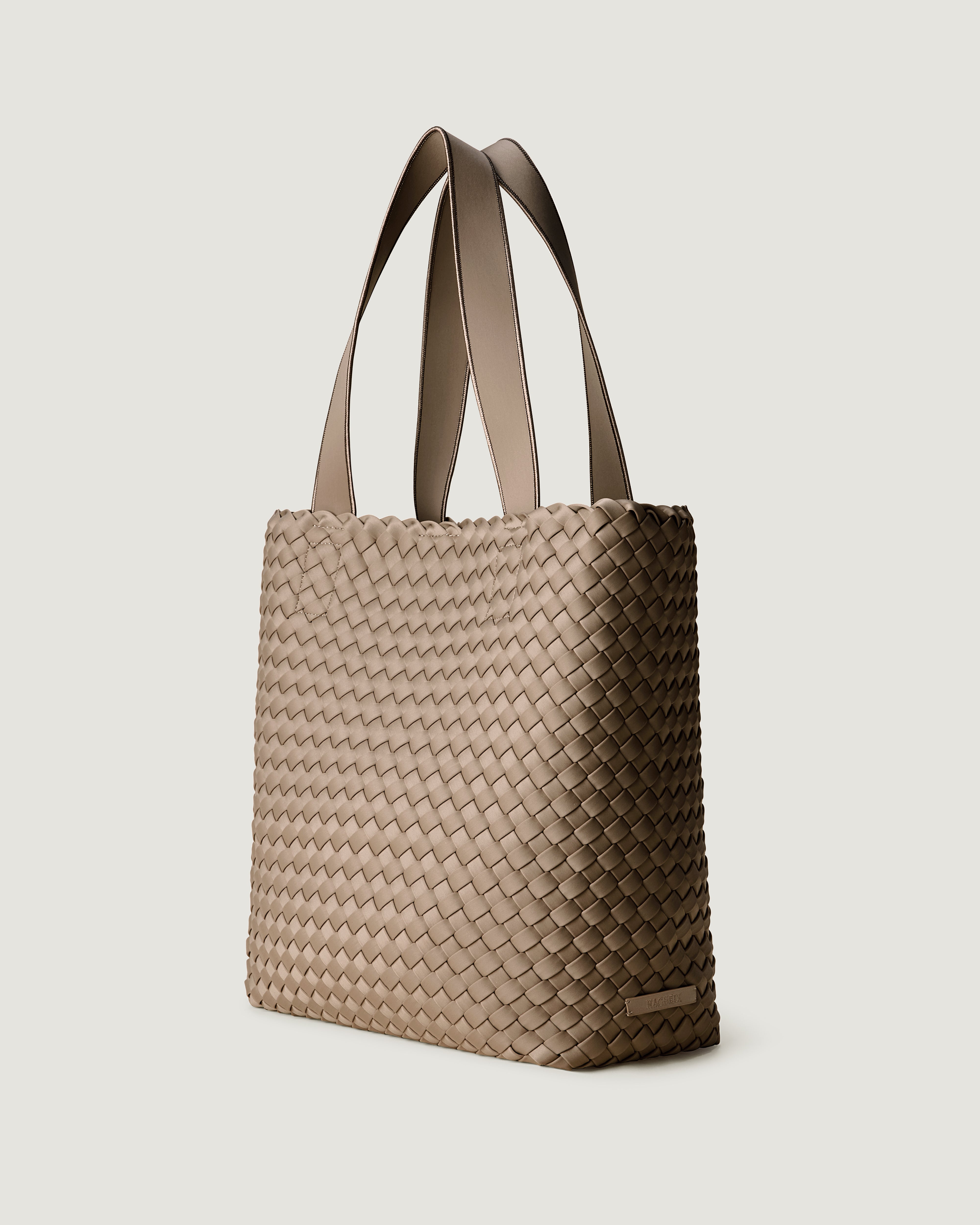 Como Tote in Cashmere shown from a side angle, highlighting its handwoven neoprene construction and open top with magnetic snap closure.