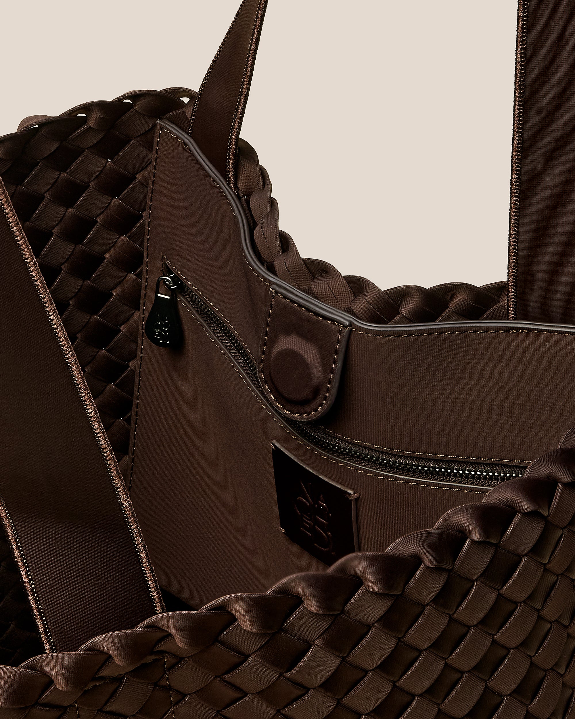 Interior close-up of Como Shopper Tote Bag in Chocolate showing its open top with magnetic snap closure, interior zip pocket, and unlined interior.
