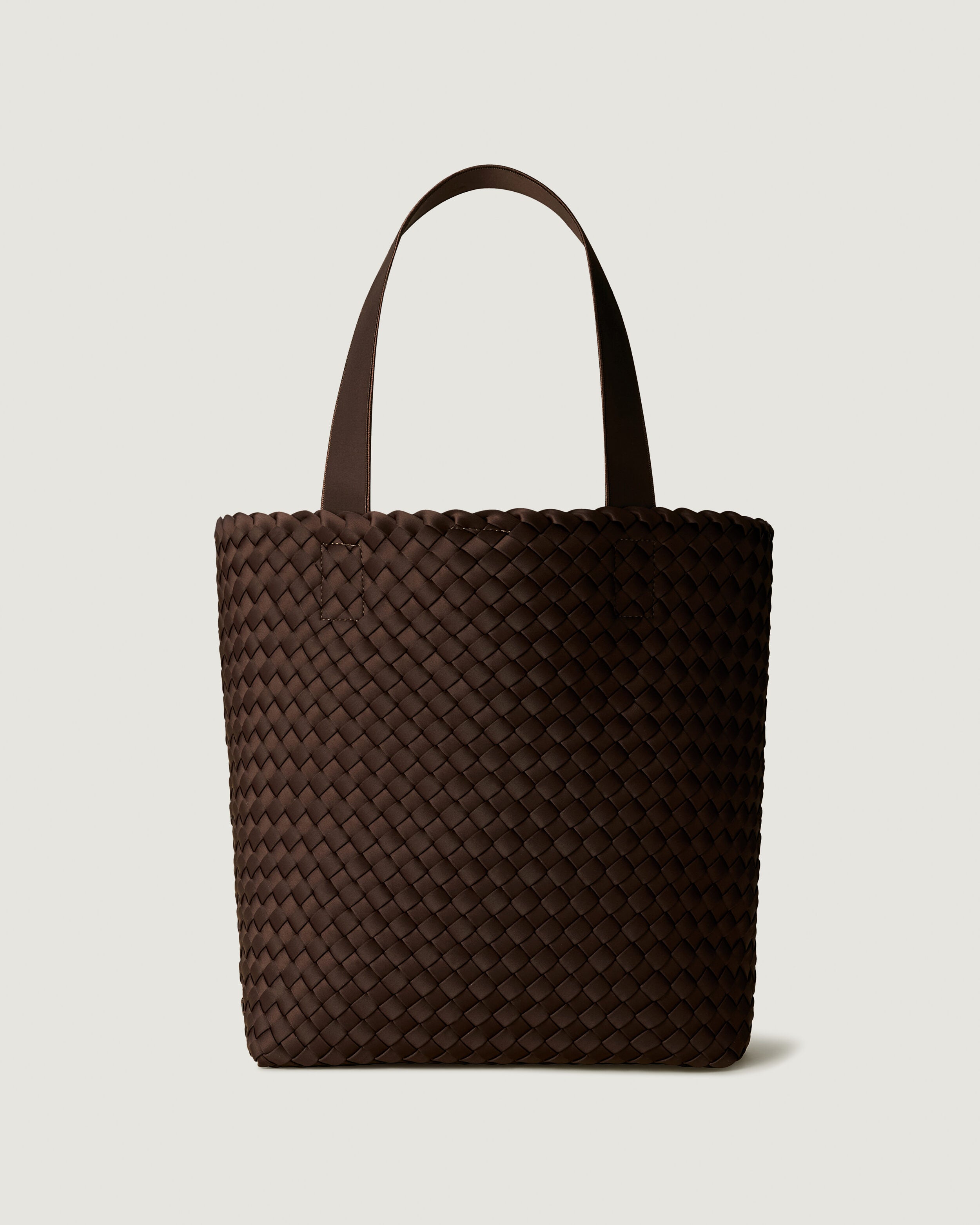 Como Tote in Chocolate, a dark chocolate brown tone, in handwoven neoprene, featuring an open top with magnetic snap closure, and neoprene shoulder straps.