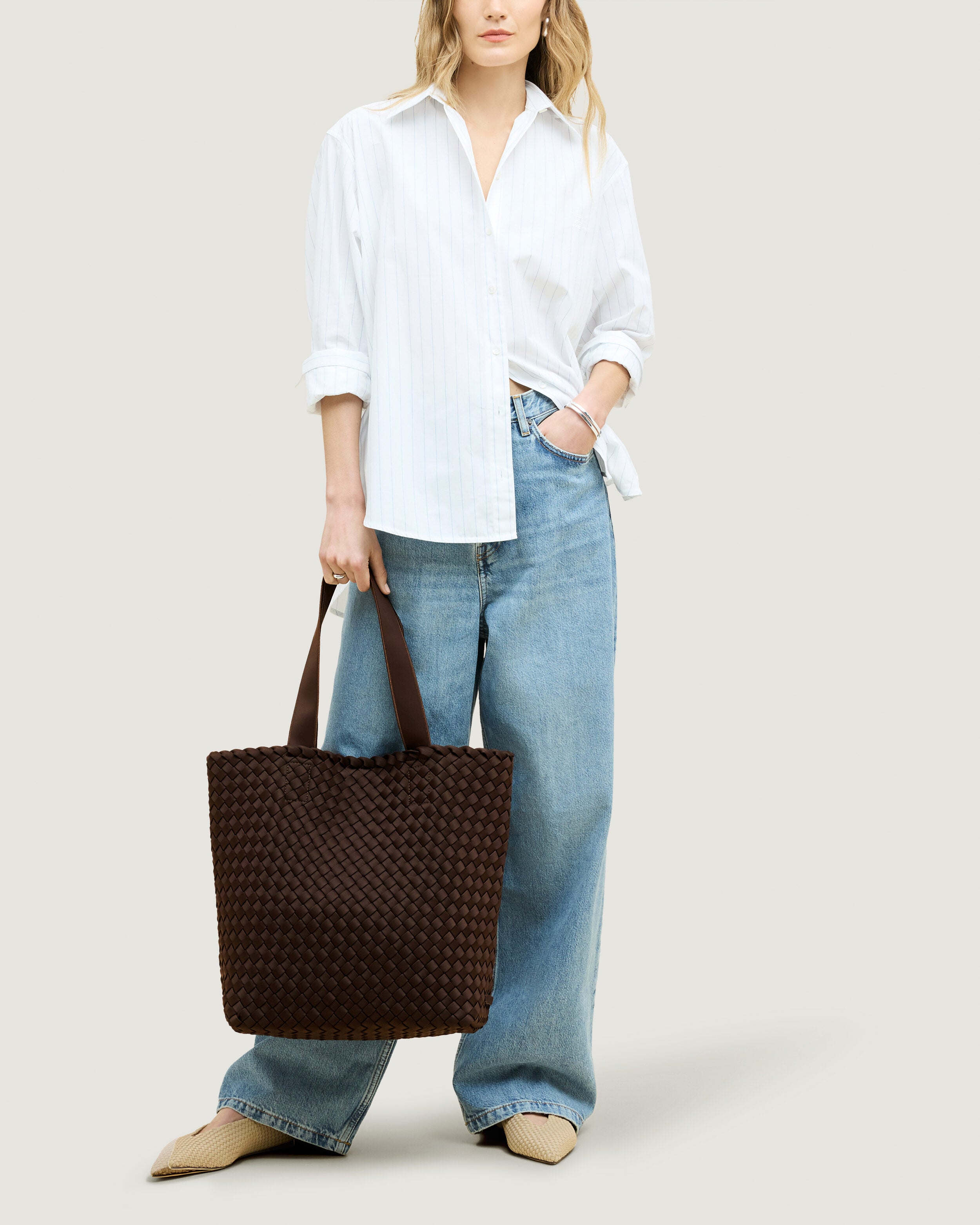 Como Tote in Chocolate shown on model to illustrate scale and soft silhouette.