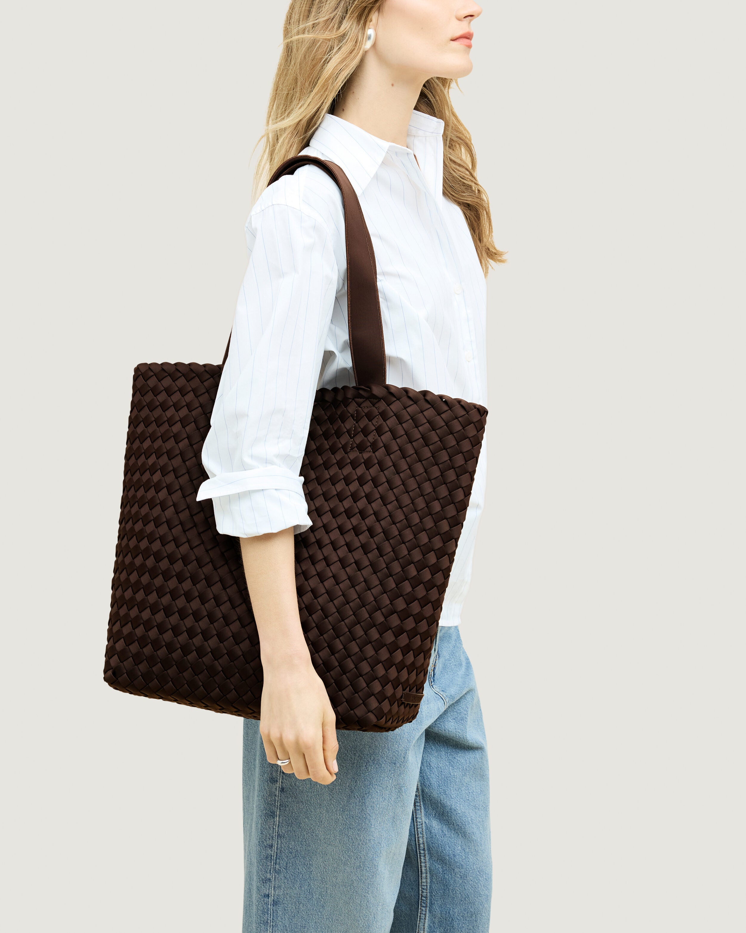 Como Tote in Chocolate shown on model to illustrate scale and soft silhouette.