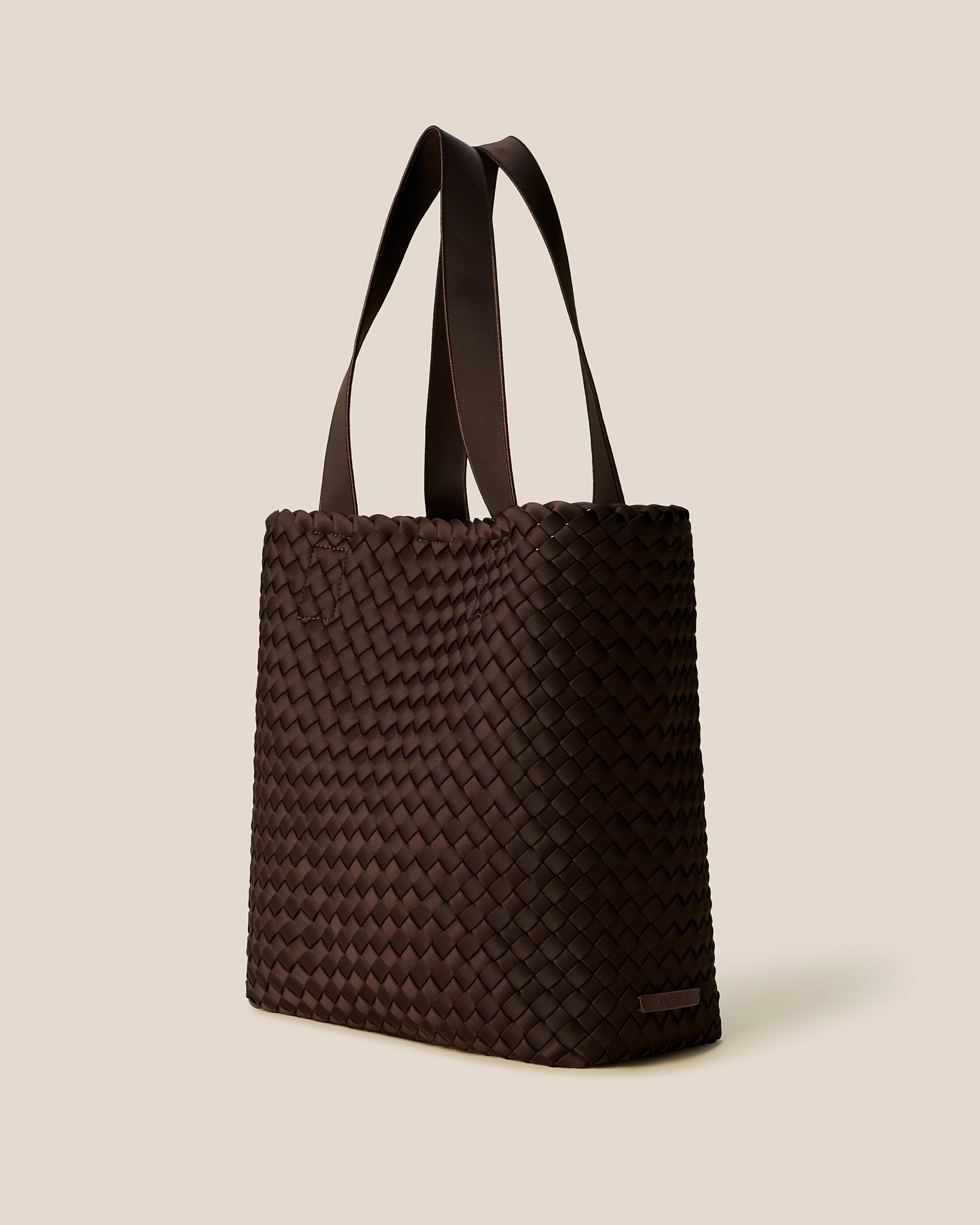 Como Shopper Tote Bag in Chocolate shown from a side angle, highlighting its handwoven neoprene and open top with magnetic snap closure.