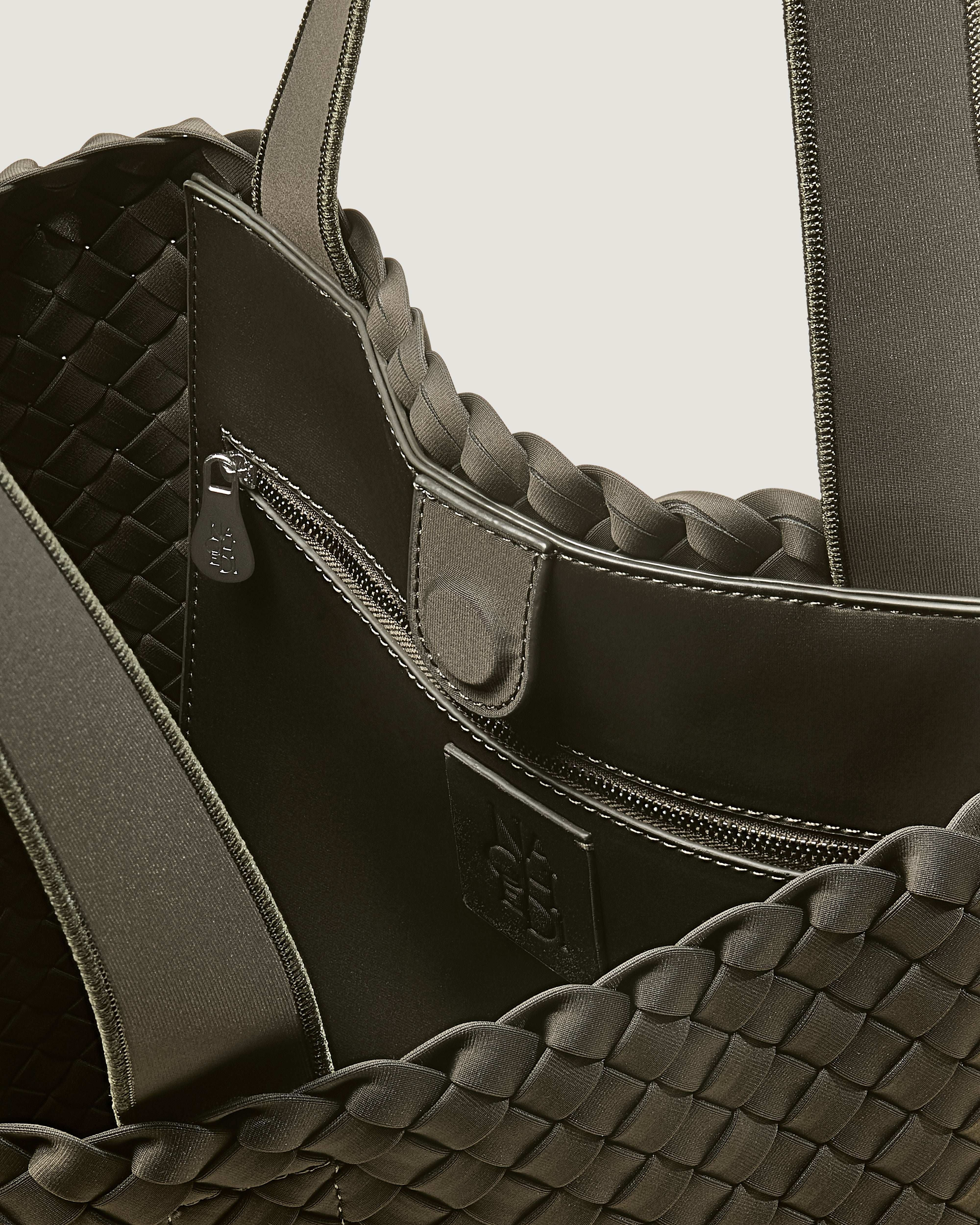Interior close-up of Como Tote in Olive showing its open top with magnetic snap closure, interior zip pocket, and unlined interior.