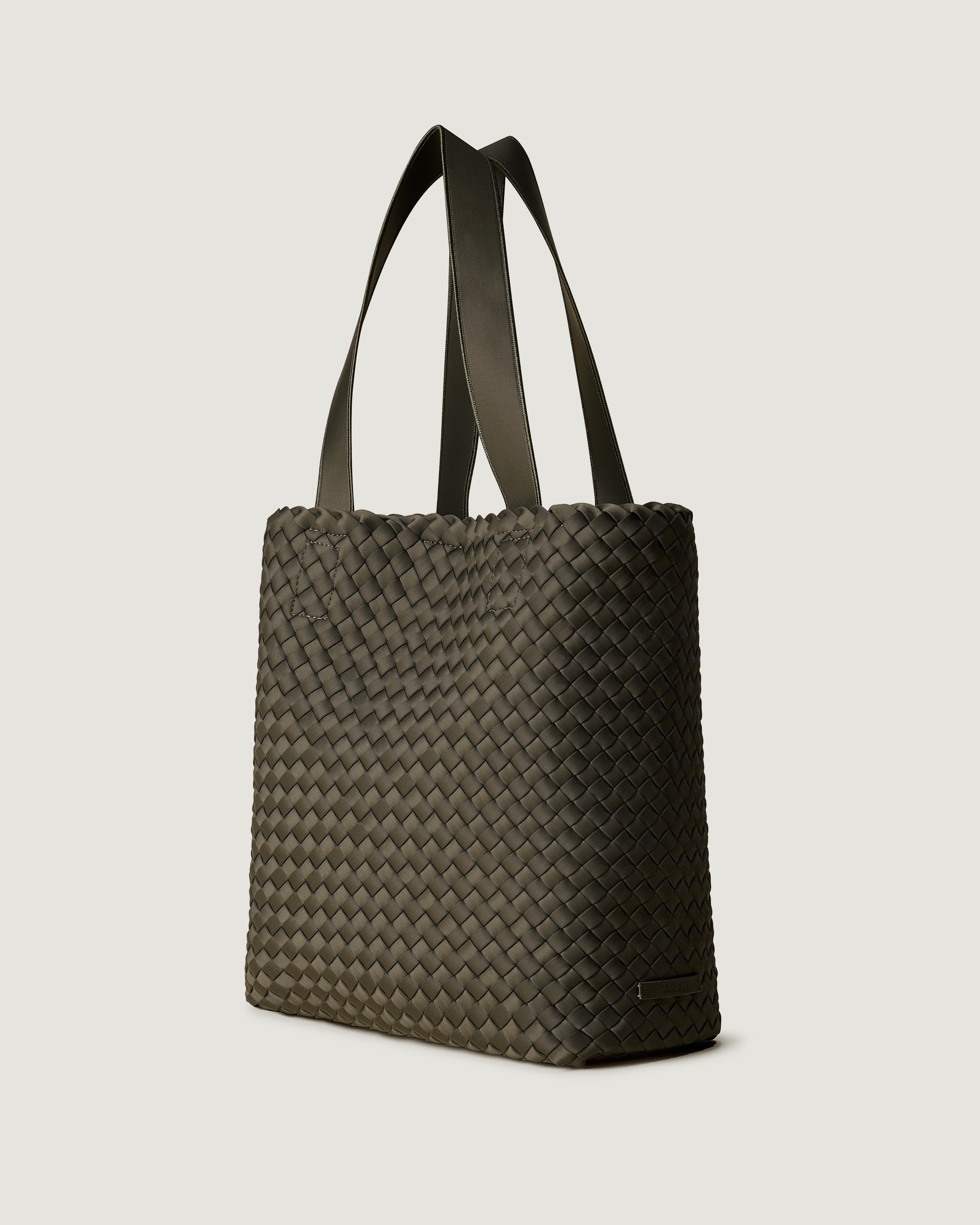 Como Tote in Olive shown from a side angle, highlighting its handwoven neoprene construction and open top with magnetic snap closure.