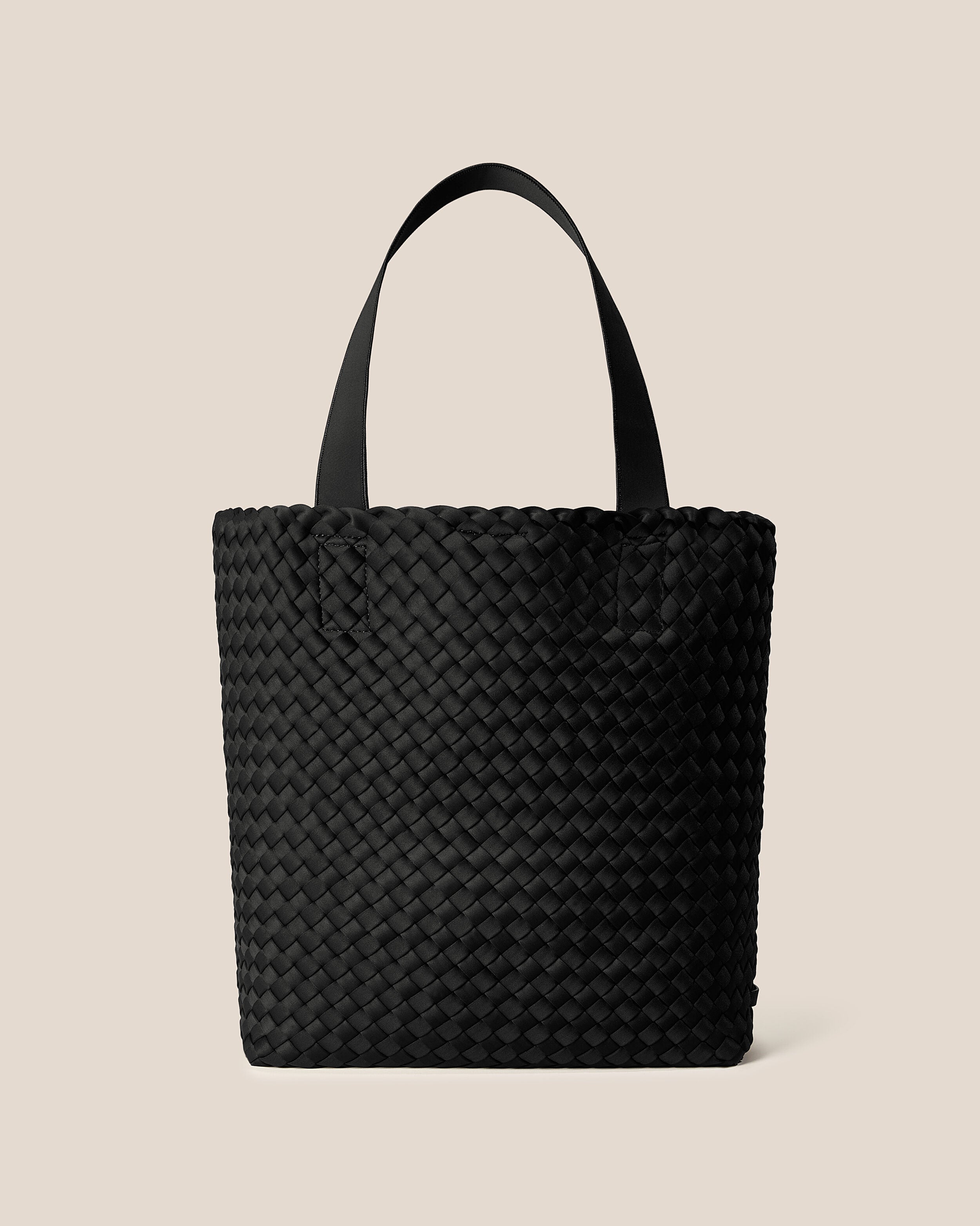 Como Tote in Onyx, a true black tone, in handwoven neoprene, featuring an open top with magnetic snap closure, and neoprene shoulder straps.