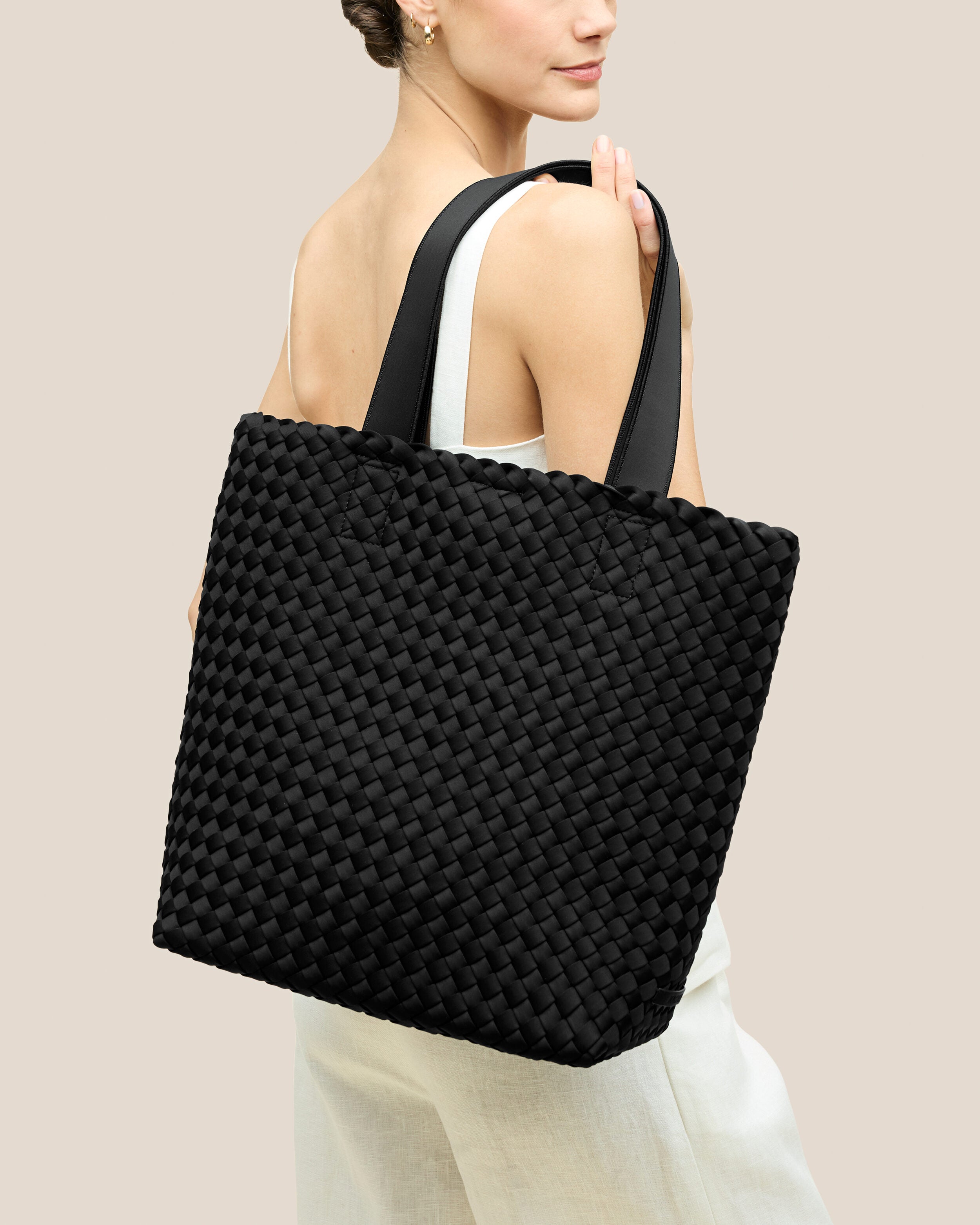 Como Tote in Onyx shown on model to illustrate scale and soft silhouette.