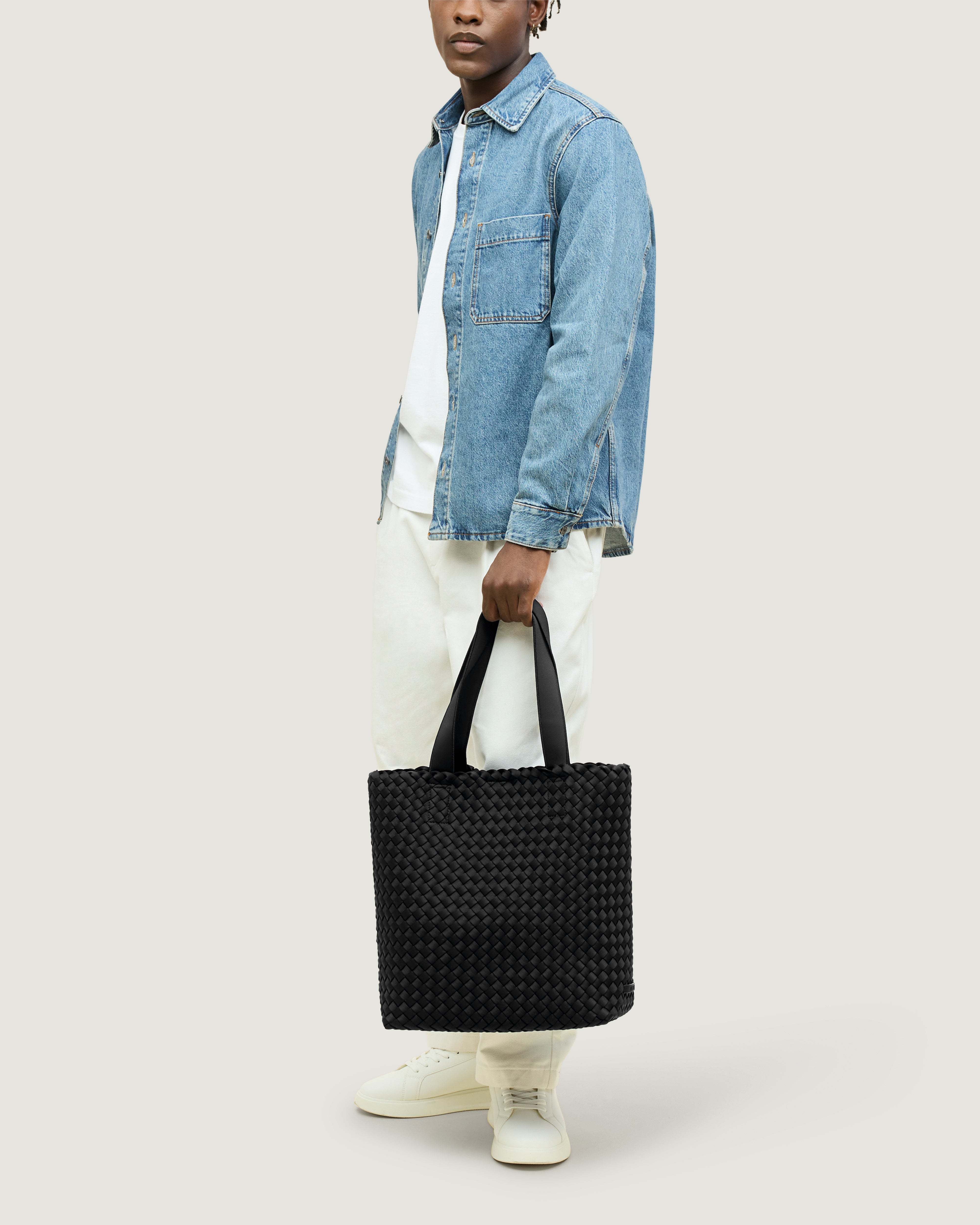 Como Tote in Onyx shown on model to illustrate scale and soft silhouette.