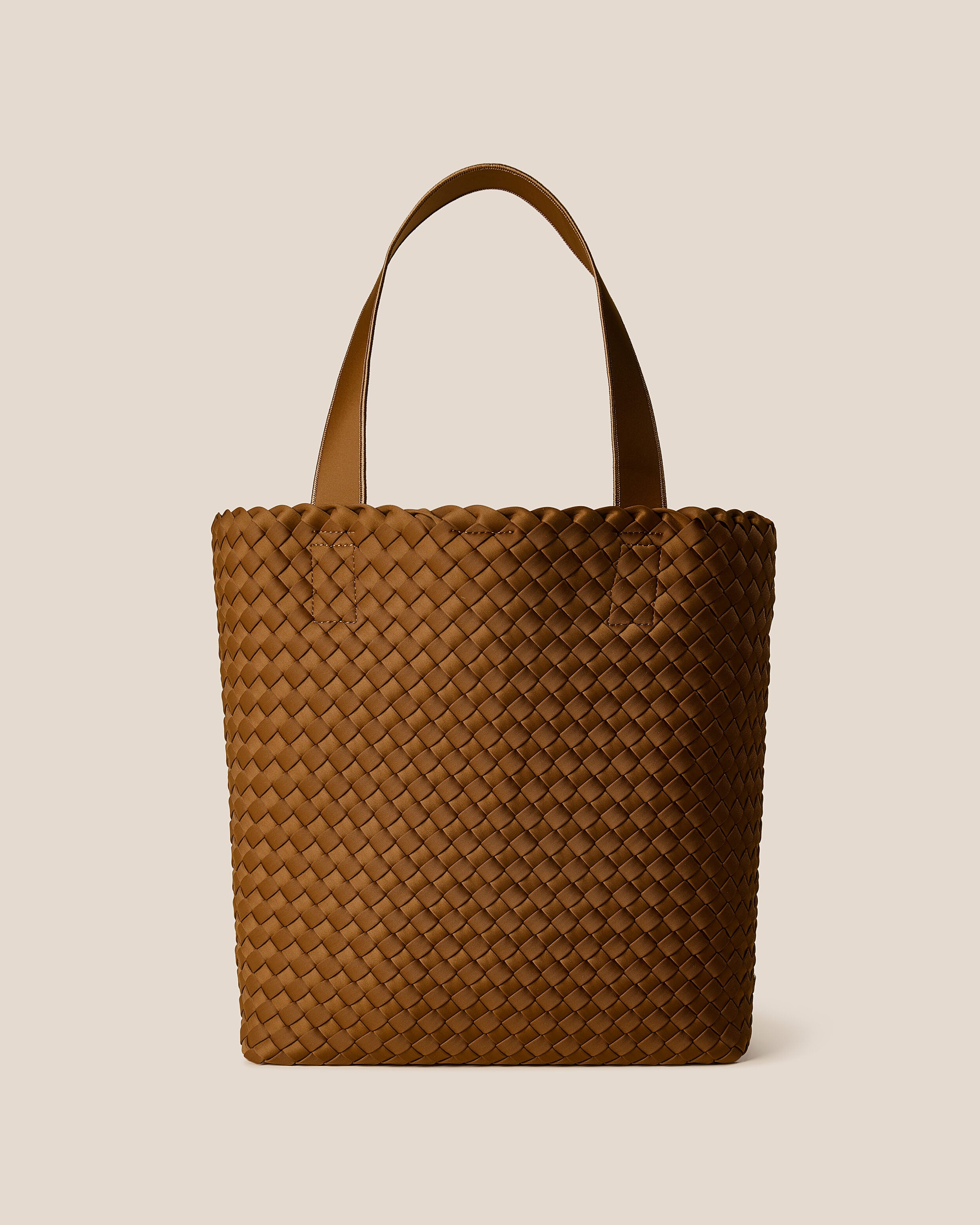 Como Tote in Teak, a saddle brown tone, in handwoven neoprene, featuring an open top with magnetic snap closure, and neoprene shoulder straps.