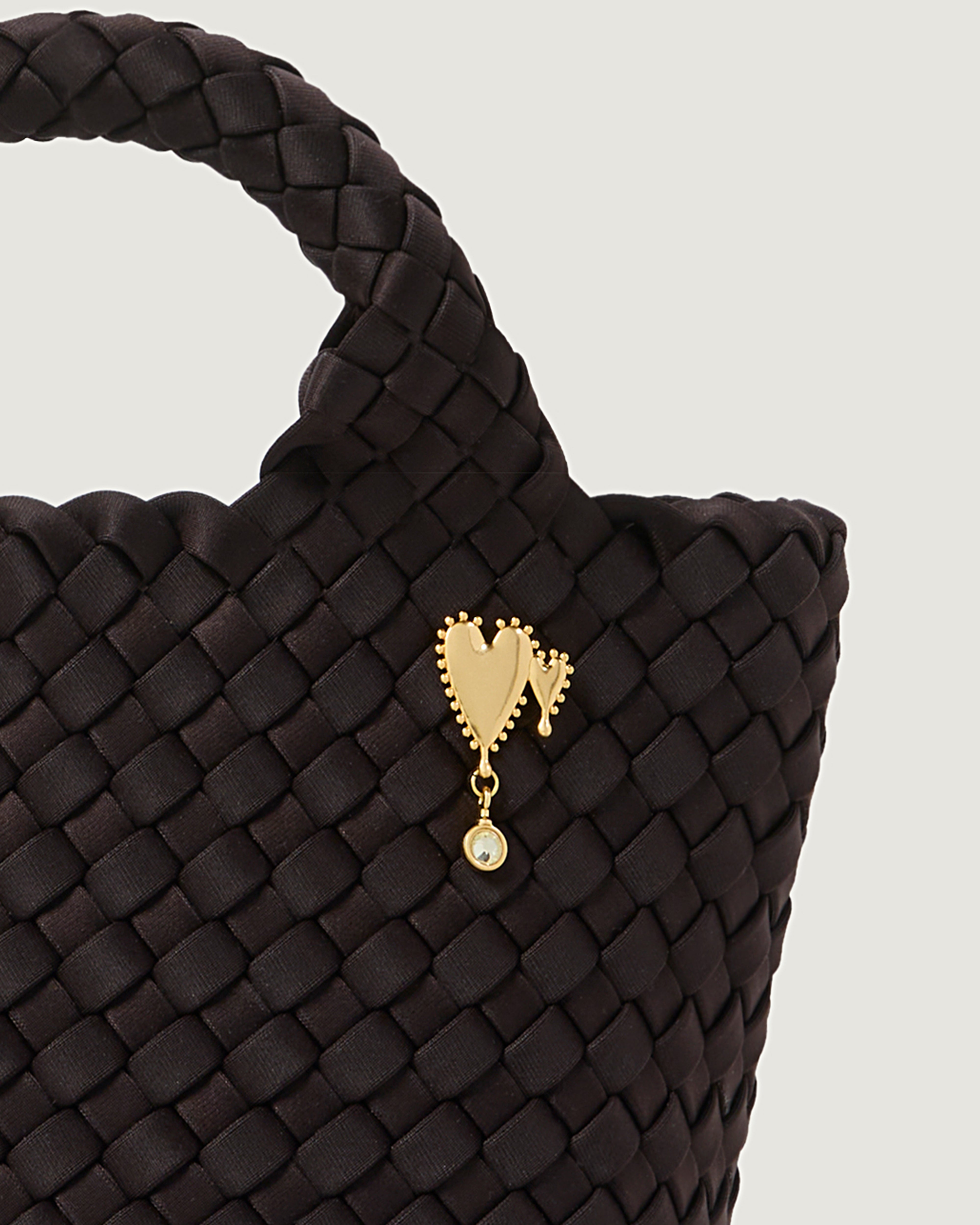 Close up image of Heart of Gold Bag Charm shown on St Barths Petit Tote.
