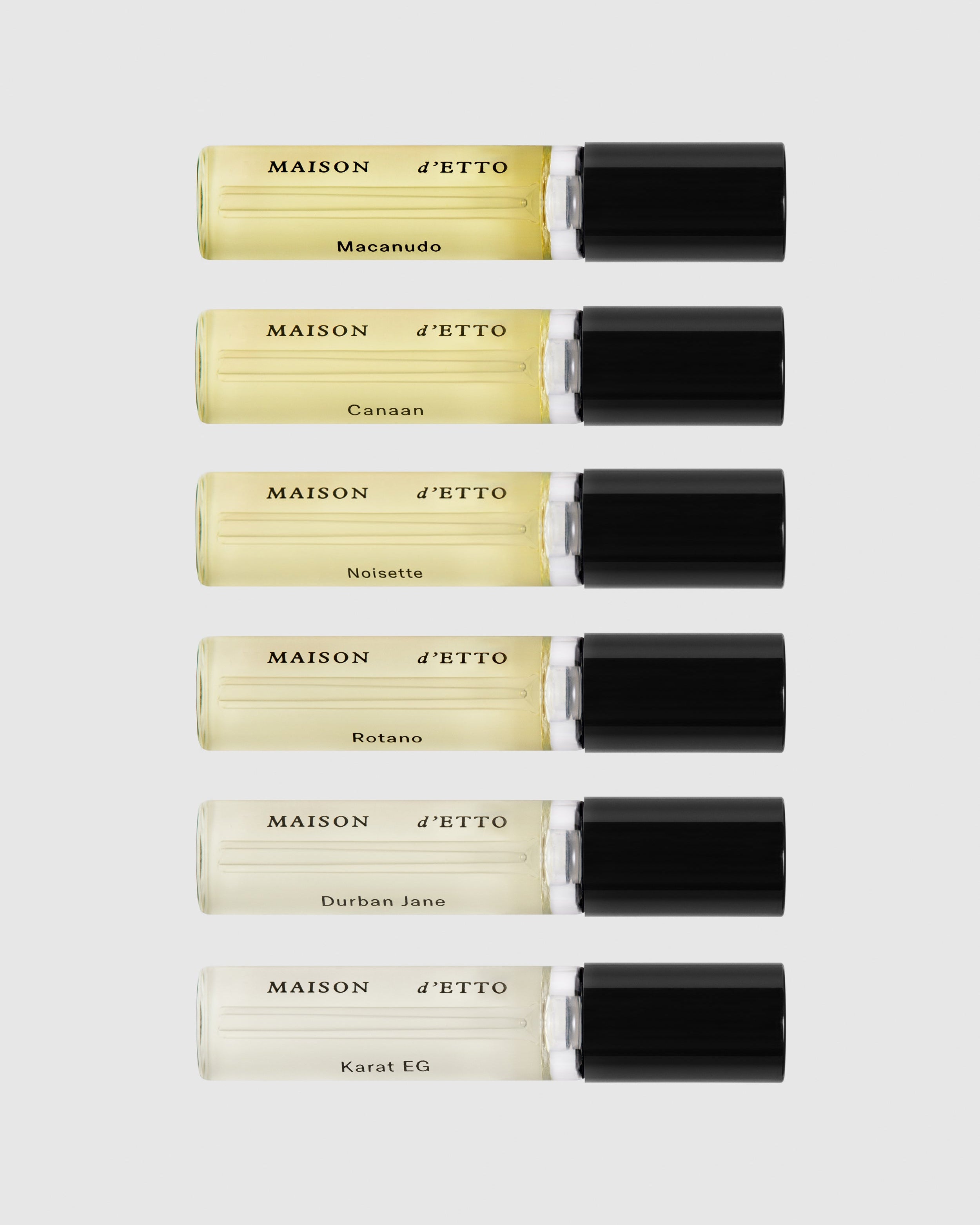 Set of Maison d'Etto perfume sample size tubes with visible branding on a white background