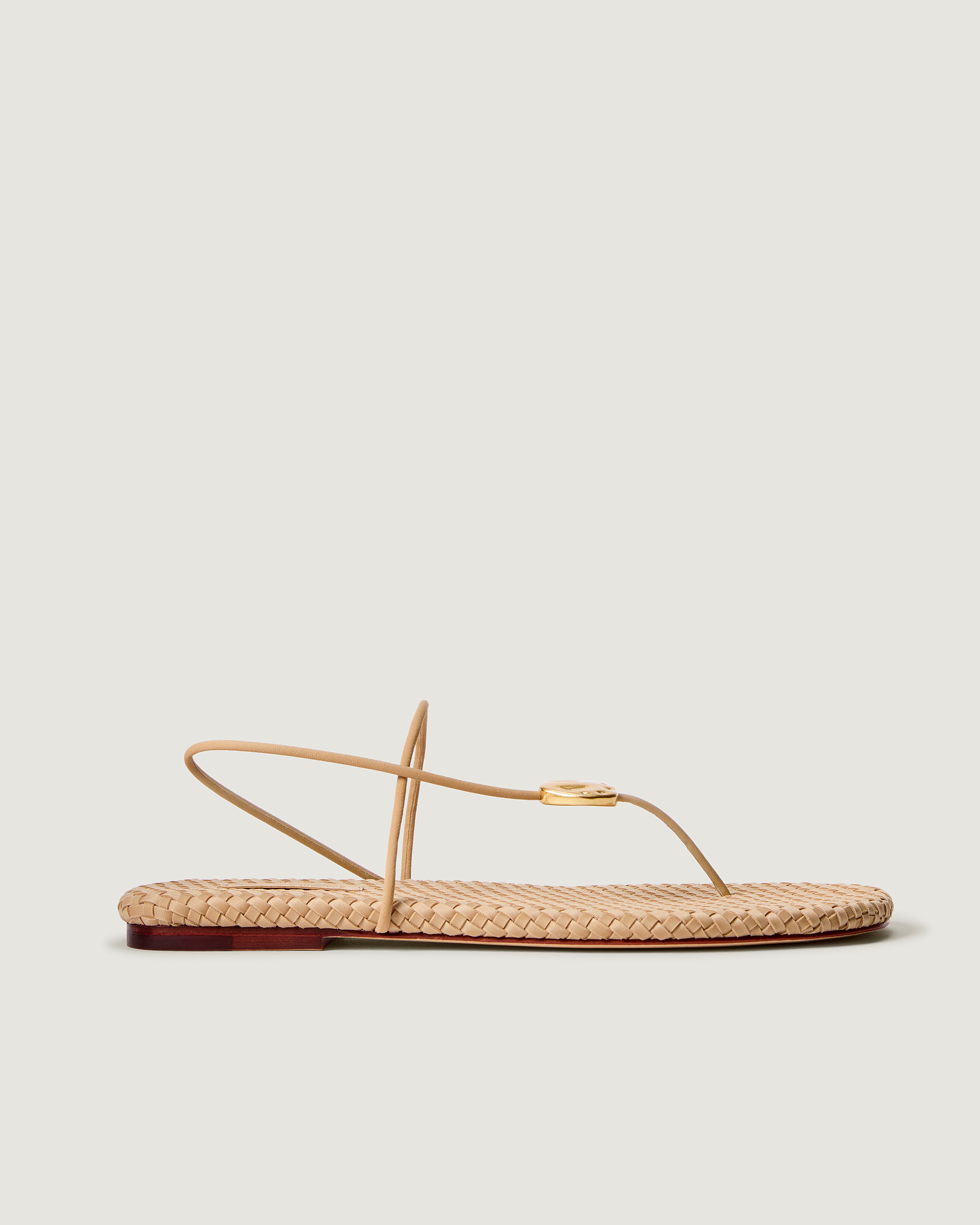 Side view of Gaia Sandal in Camel, featuring 2 thin straps hammered metallic disc detail.