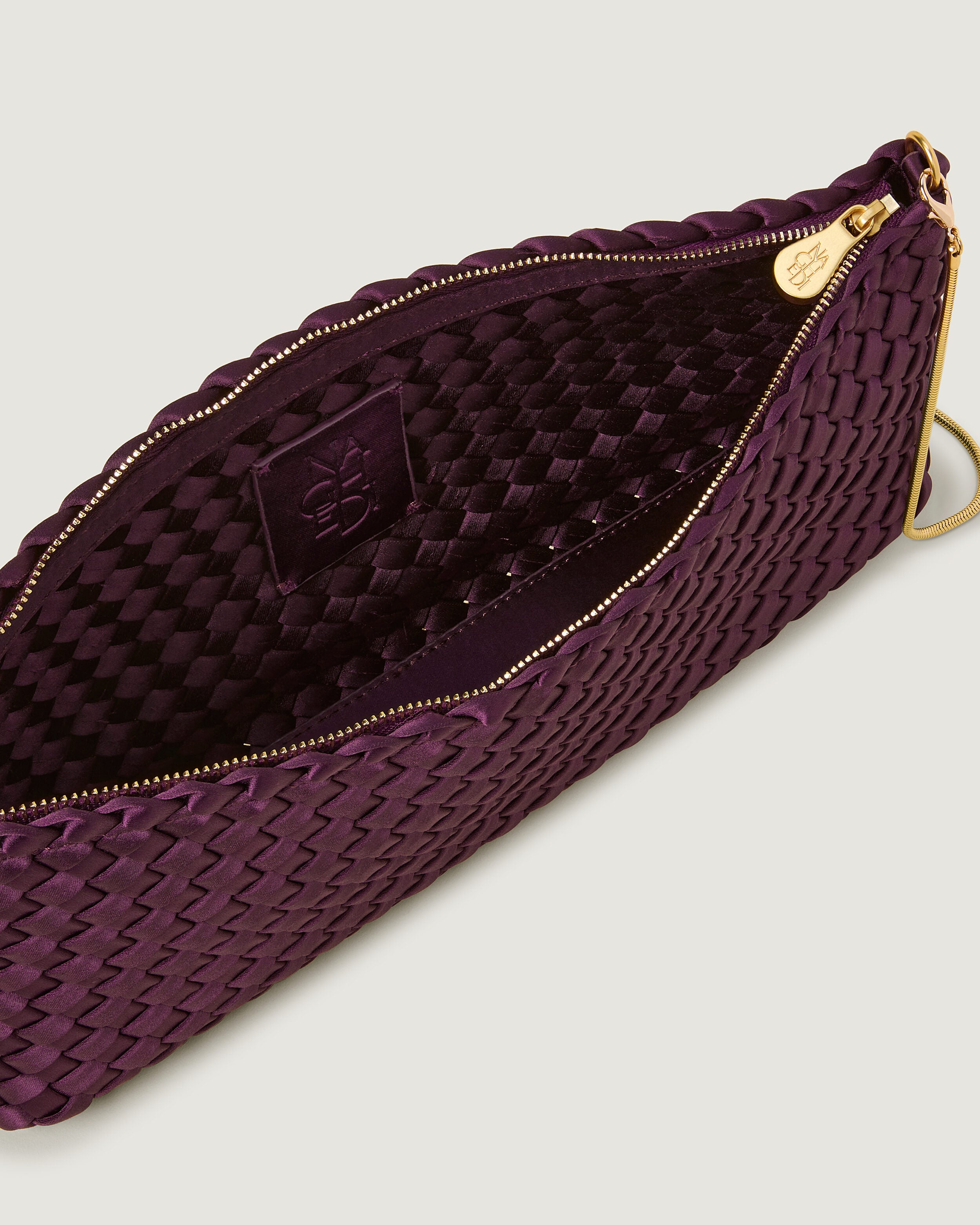 Interior close-up of Gala Clutch in Currant showing its top zip closure.