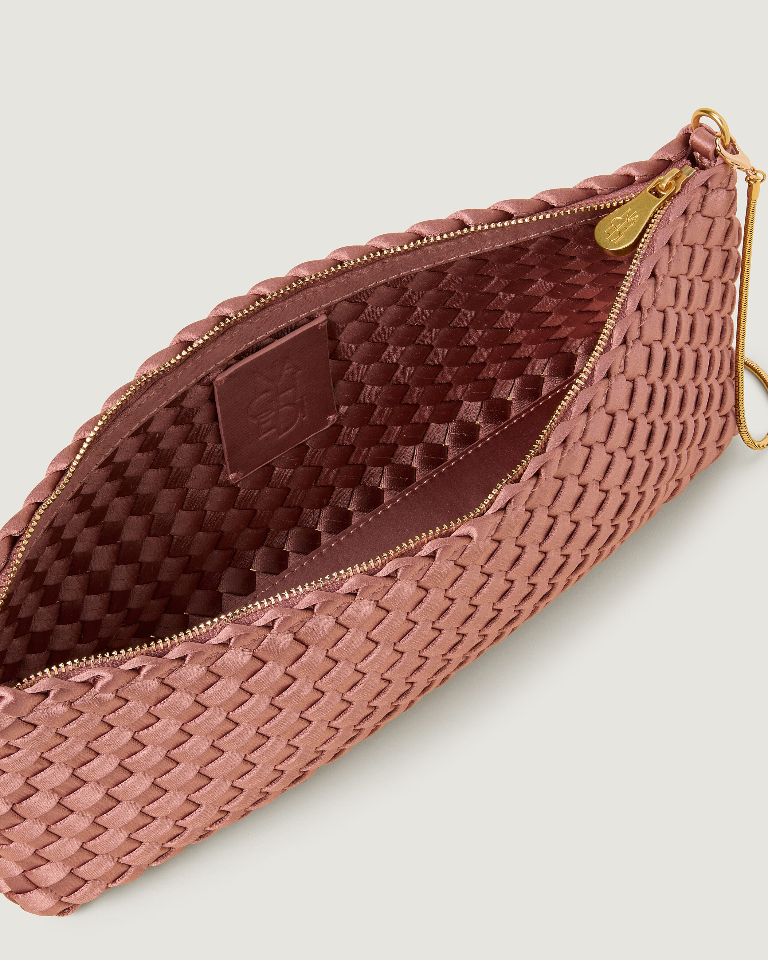 Interior close-up of Gala Clutch in Daphne showing its top zip closure.
