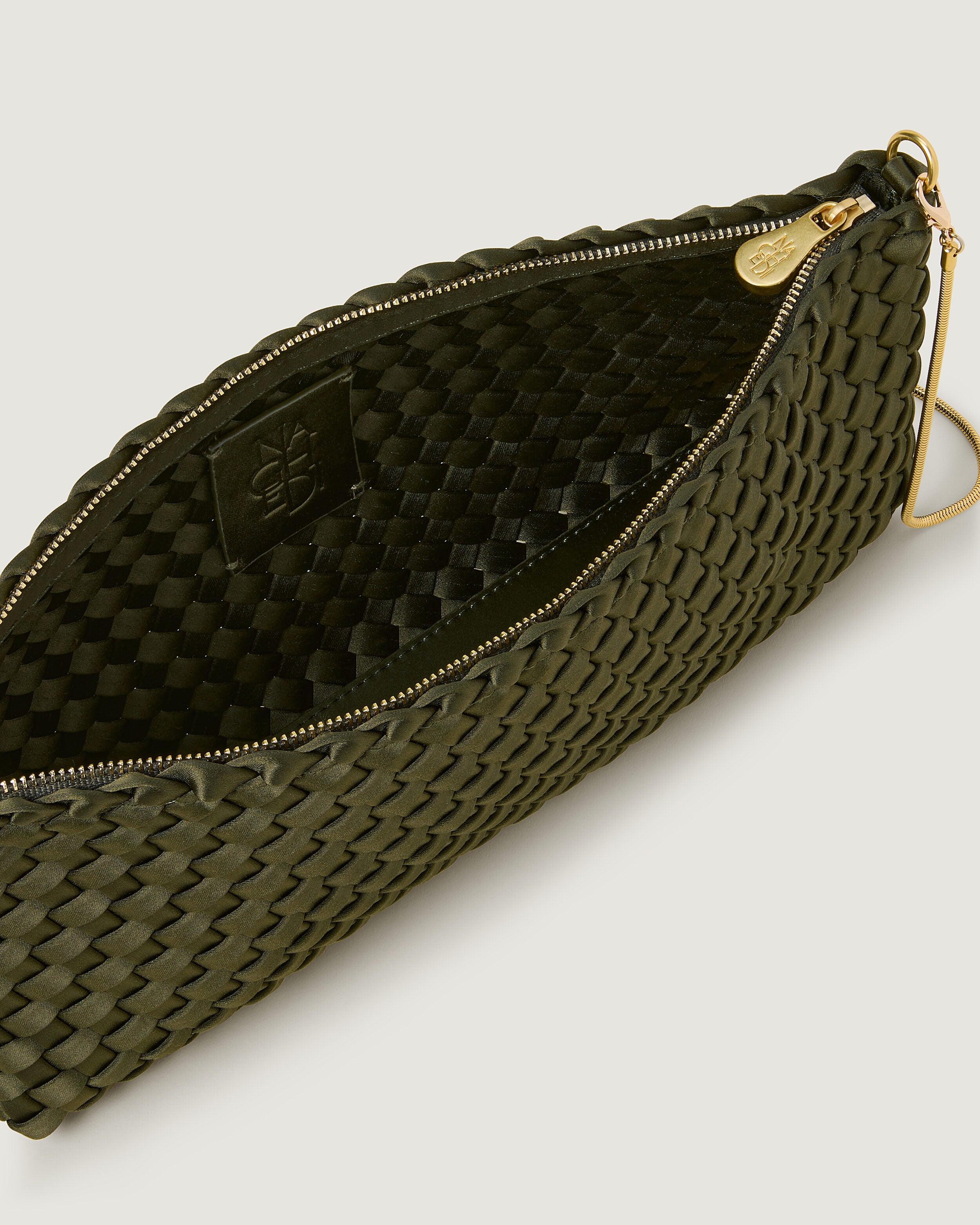 Interior close-up of Gala Clutch in Juniper showing its top zip closure.