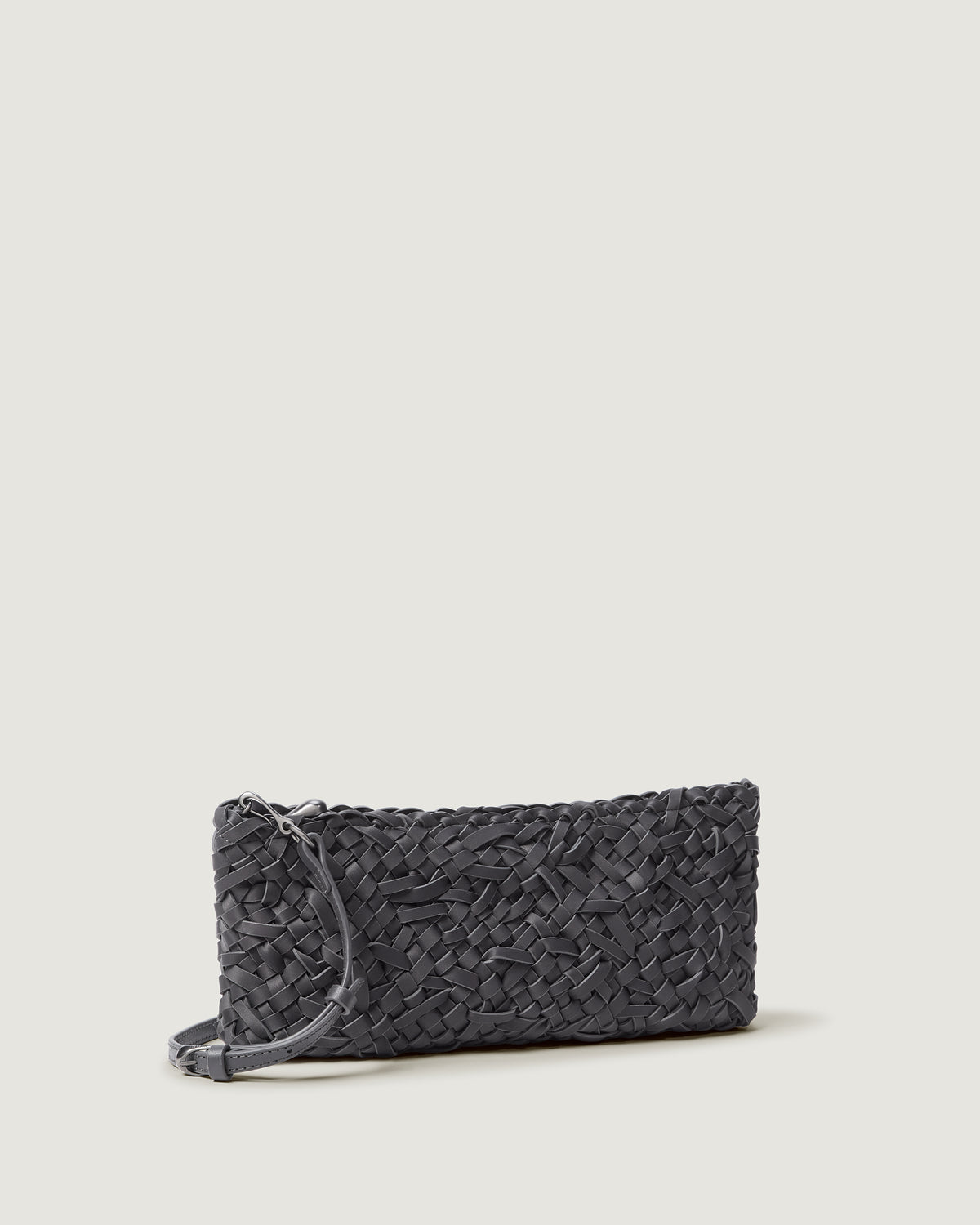 Side view of handwoven neoprene shoulder bag in ash gray color with a crosshatch nest weave pattern and silver hardware.