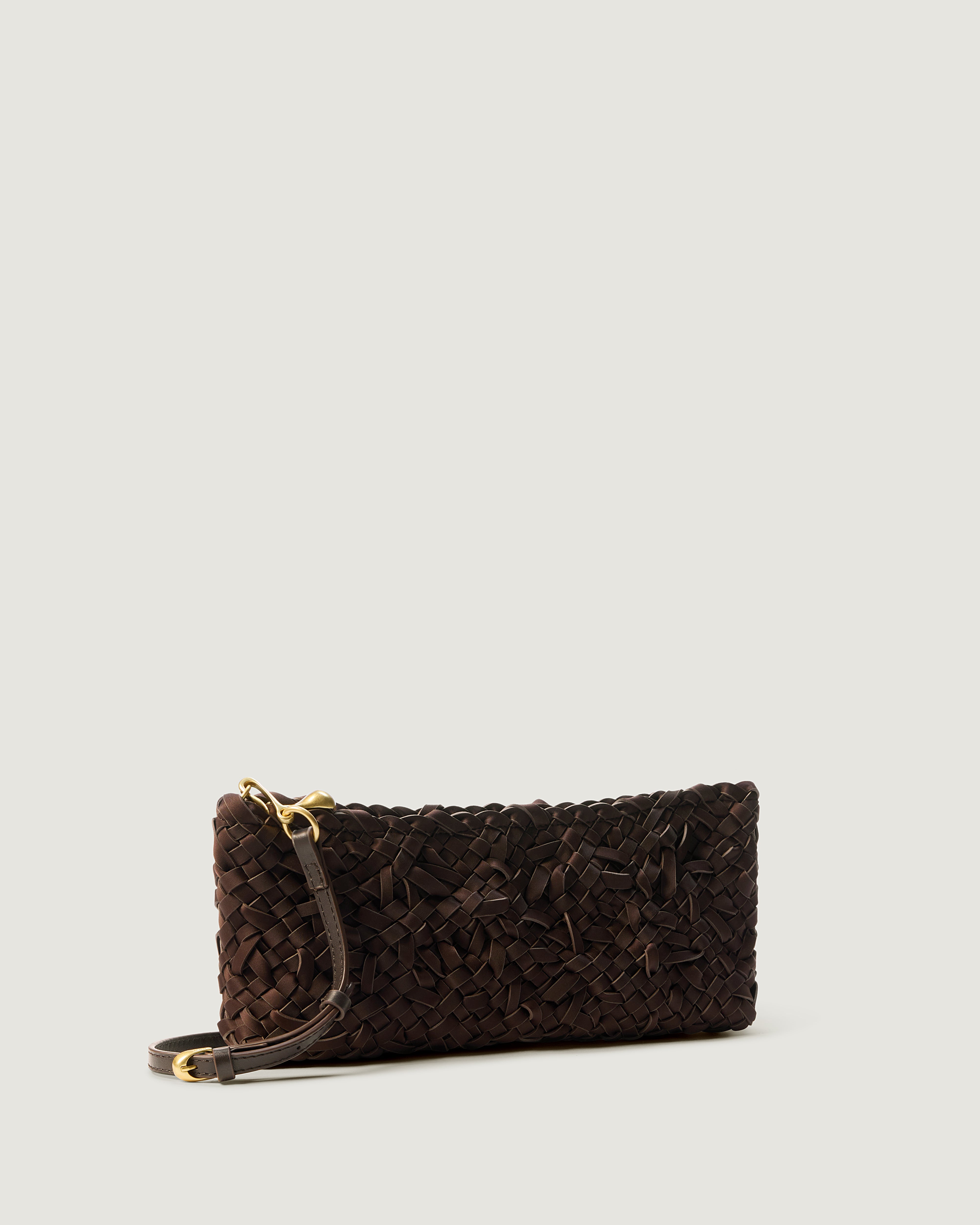 Side view of handwoven neoprene shoulder bag in chocolate brown color with a crosshatch nest weave pattern and gold hardware.