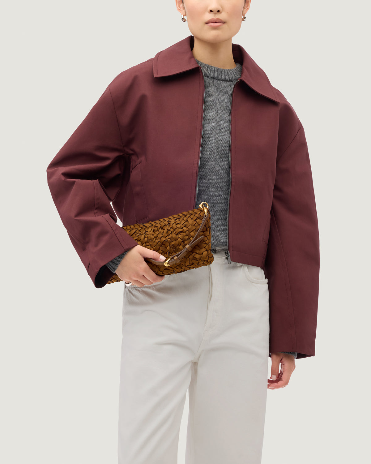 Nest Weave Gala Clutch in Teak shown on model to demonstrate shape and soft silhouette.