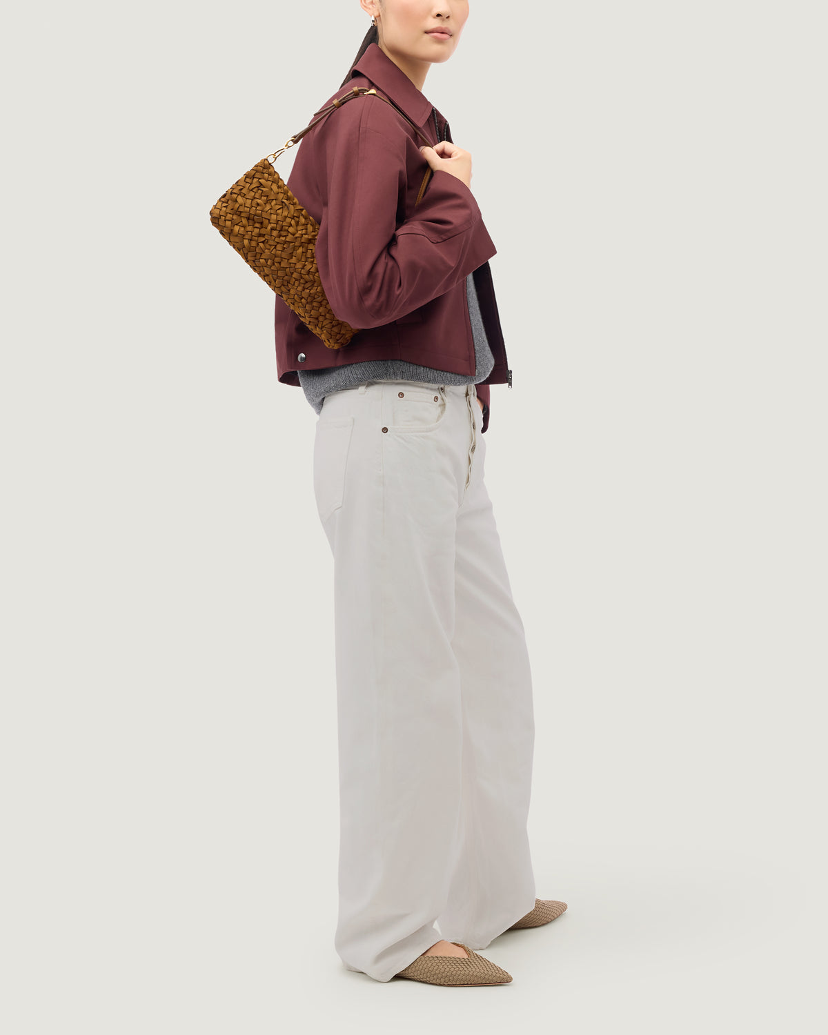 Nest Weave Gala Clutch in Teak shown on model to demonstrate shape and soft silhouette.