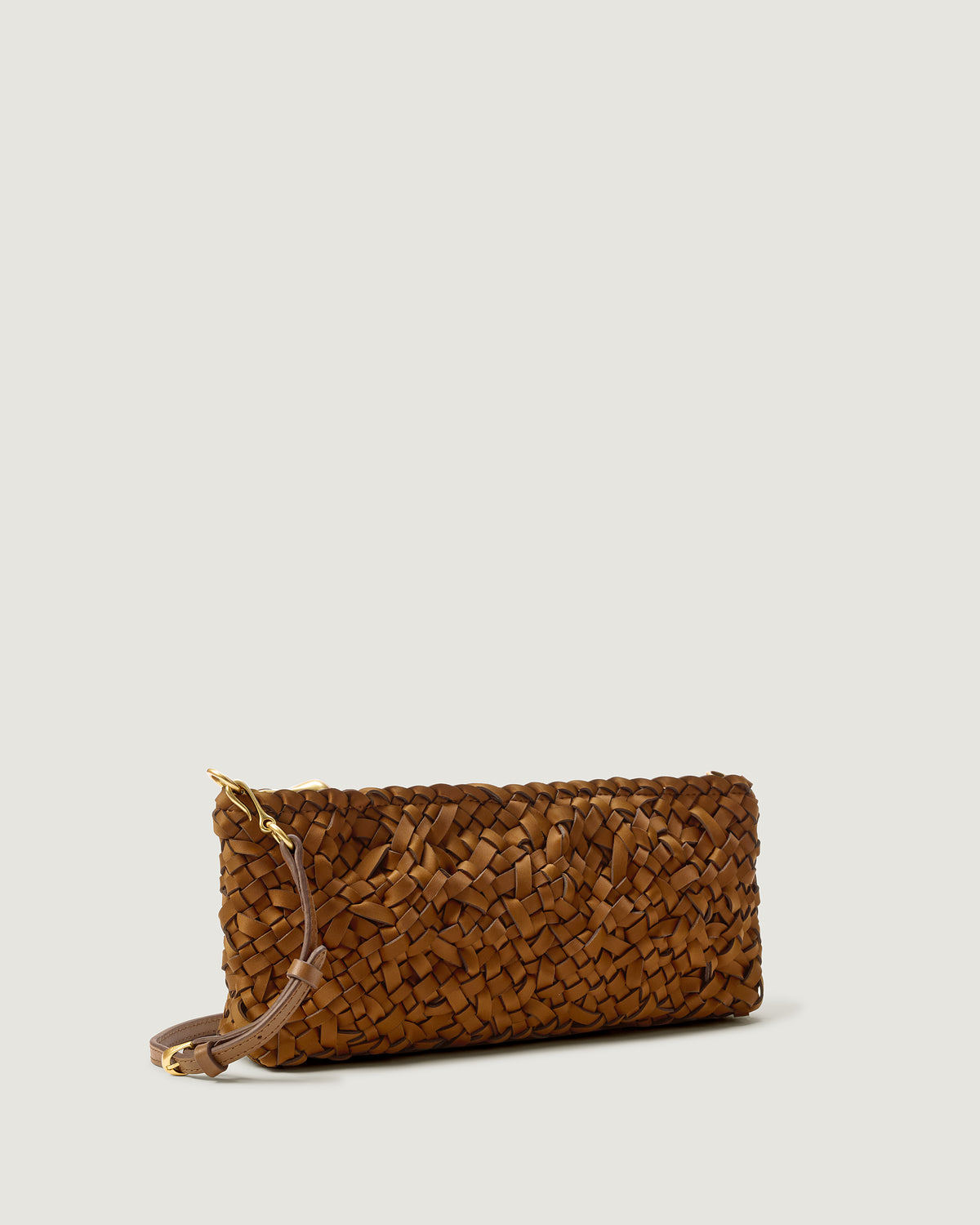 Side view of Gala Clutch, a handwoven neoprene shoulder bag in saddle brown color with a crosshatch nest weave pattern and gold hardware.