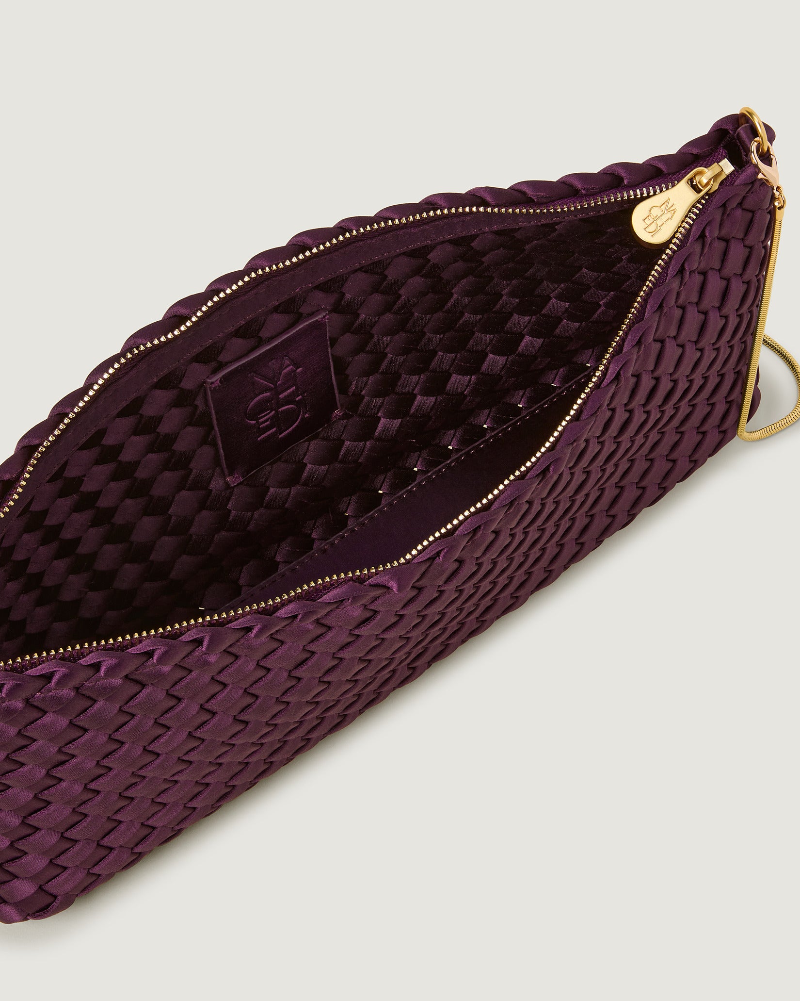 Interior close-up of Gala Medium Satin Clutch Bag in Currant showing its top zip closure.