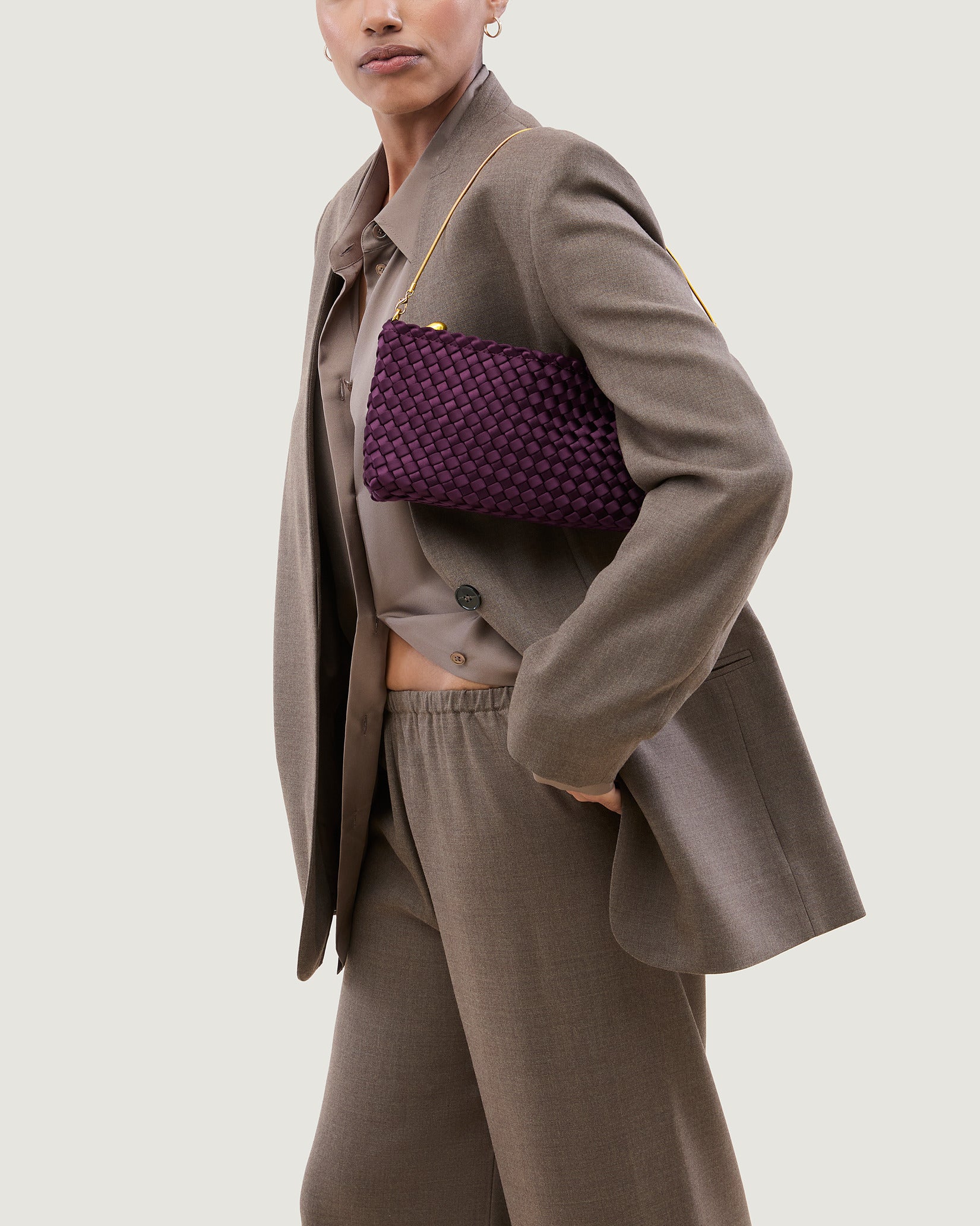 Gala Medium Satin Clutch Bag in Currant shown on model to illustrate scale and soft silhouette.