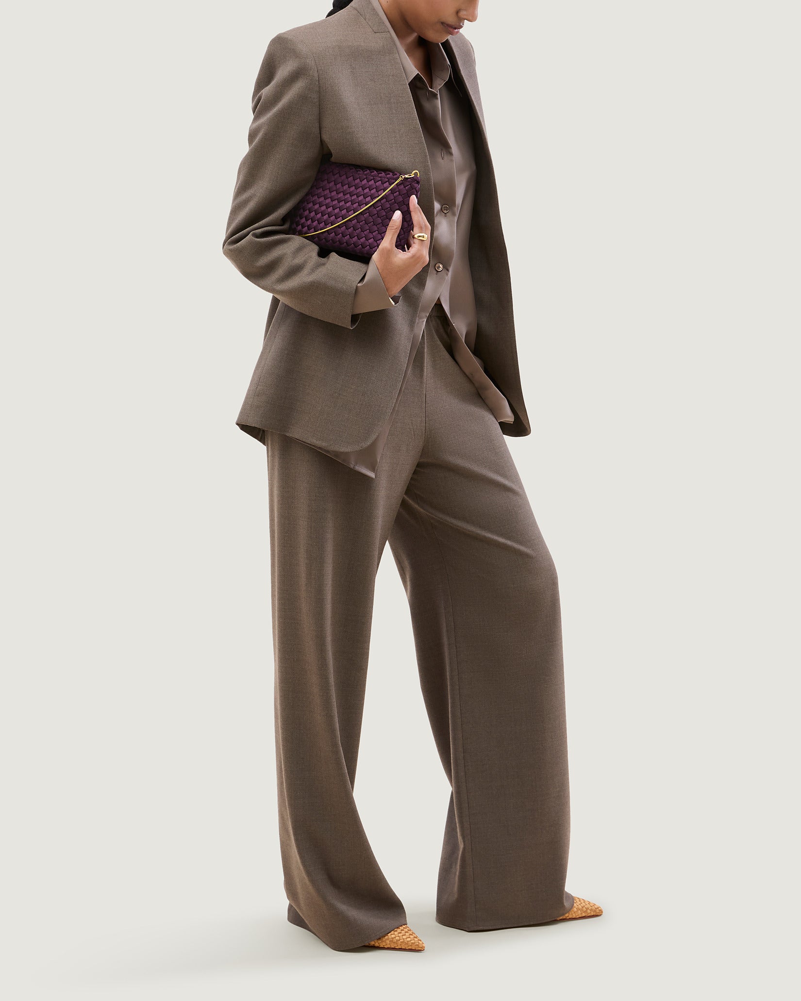 Gala Medium Satin Clutch Bag in Currant shown on model to illustrate scale and soft silhouette.