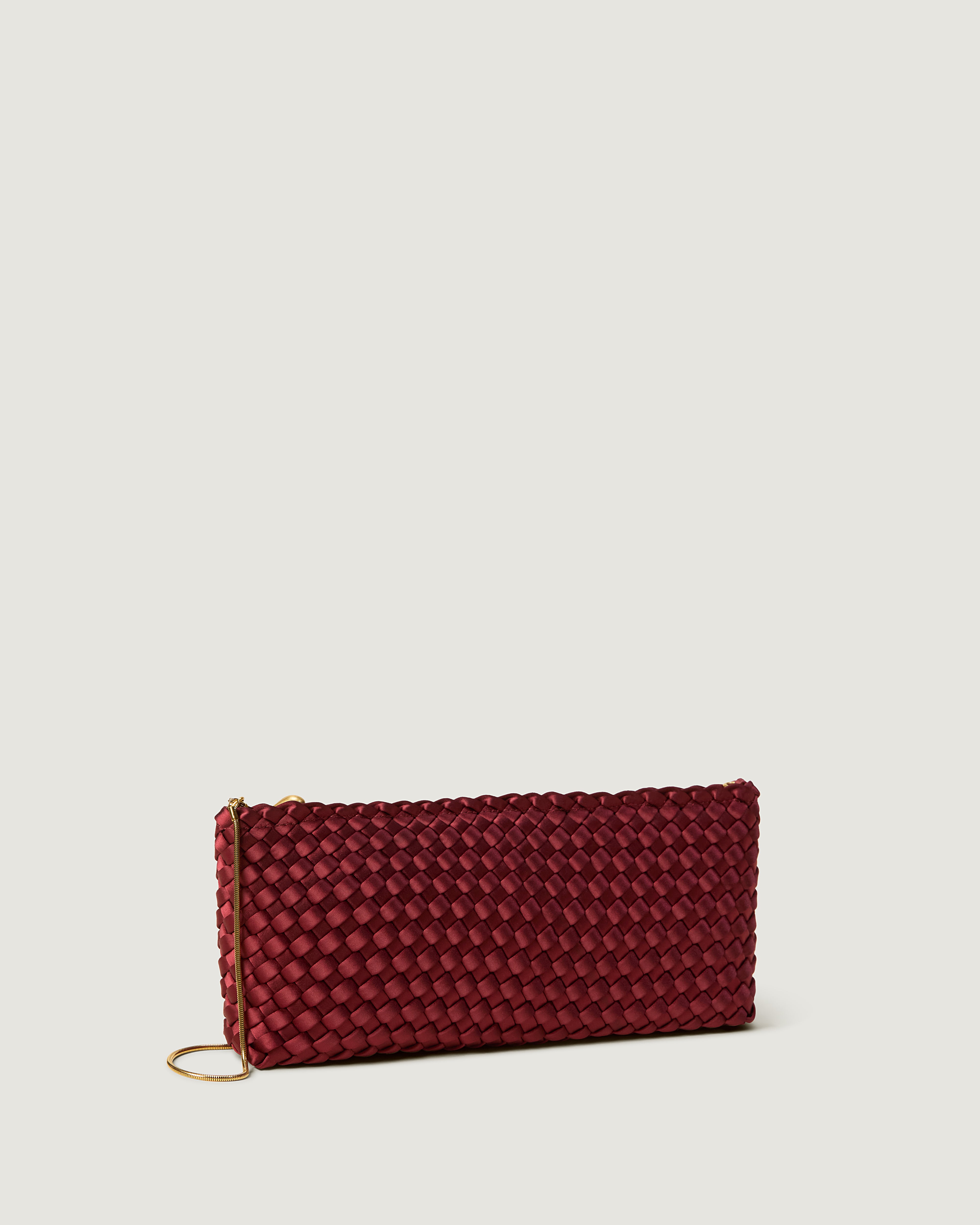 Gala Clutch in Garnet shown from a side angle, highlighting its handwoven satin construction and top zip closure.