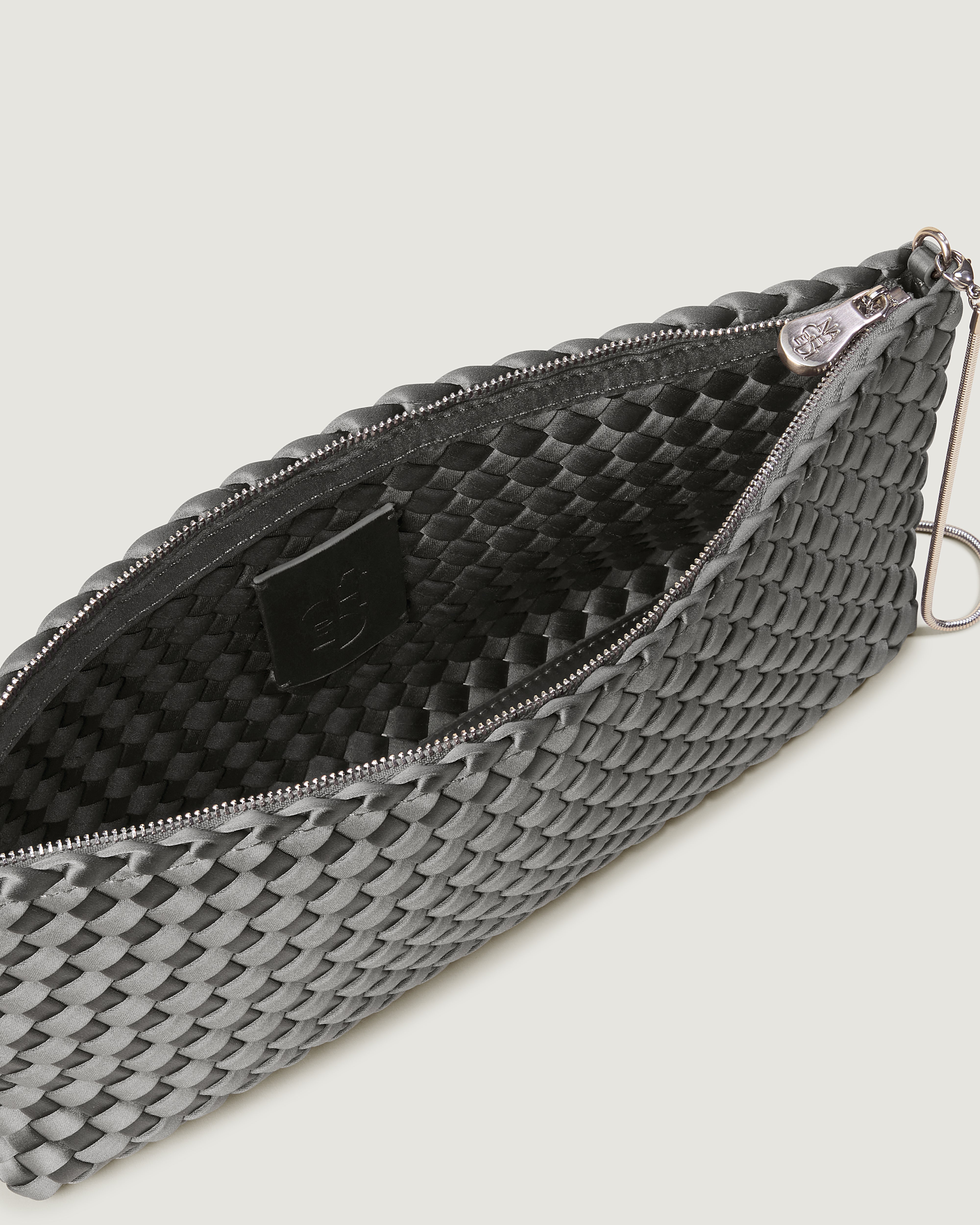 Interior close-up of Gala Clutch in Graphite showing its top zip closure.