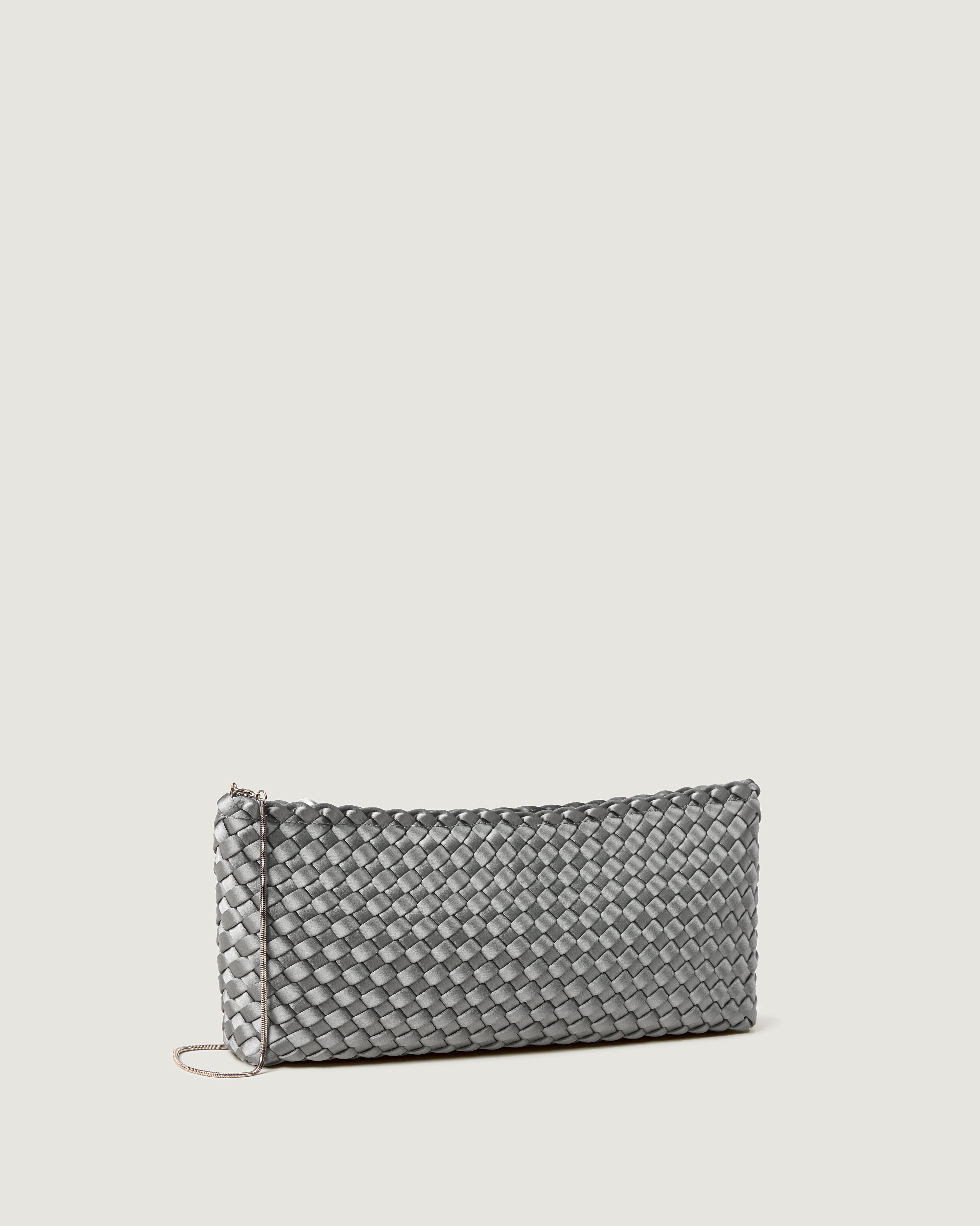 Gala Clutch in Graphite shown from a side angle, highlighting its handwoven satin construction and top zip closure.