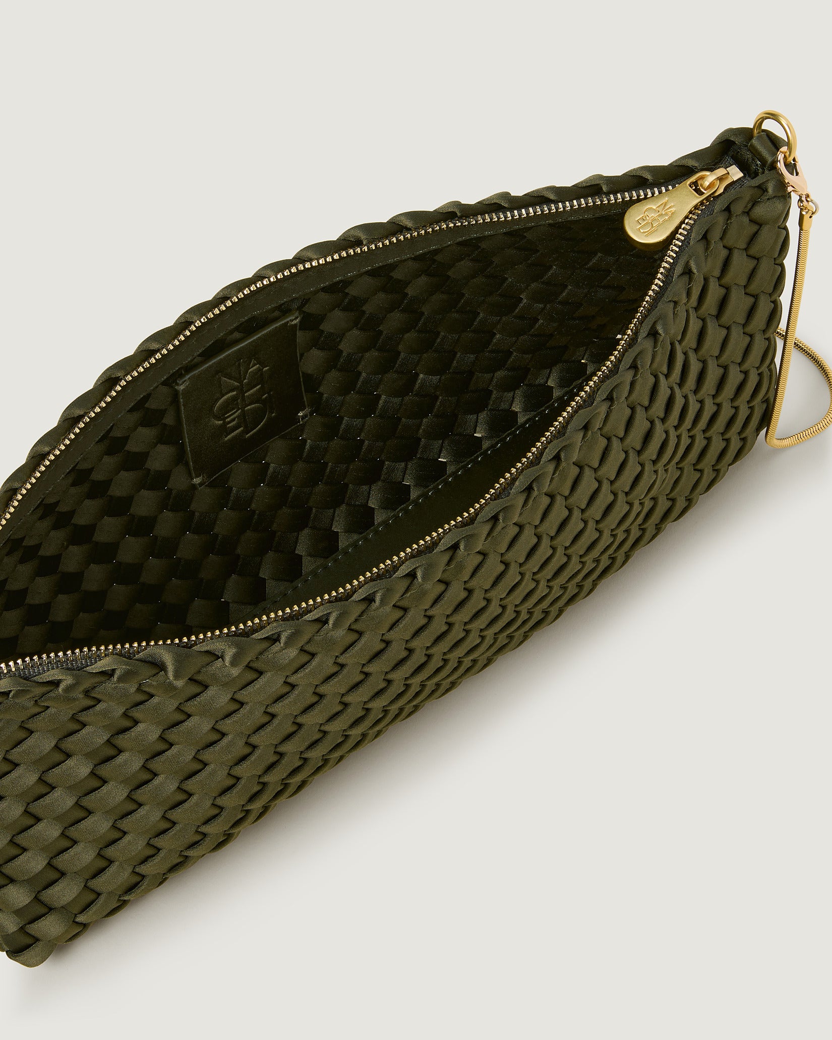 Interior close-up of Gala Medium Satin Clutch Bag in Juniper showing its top zip closure.