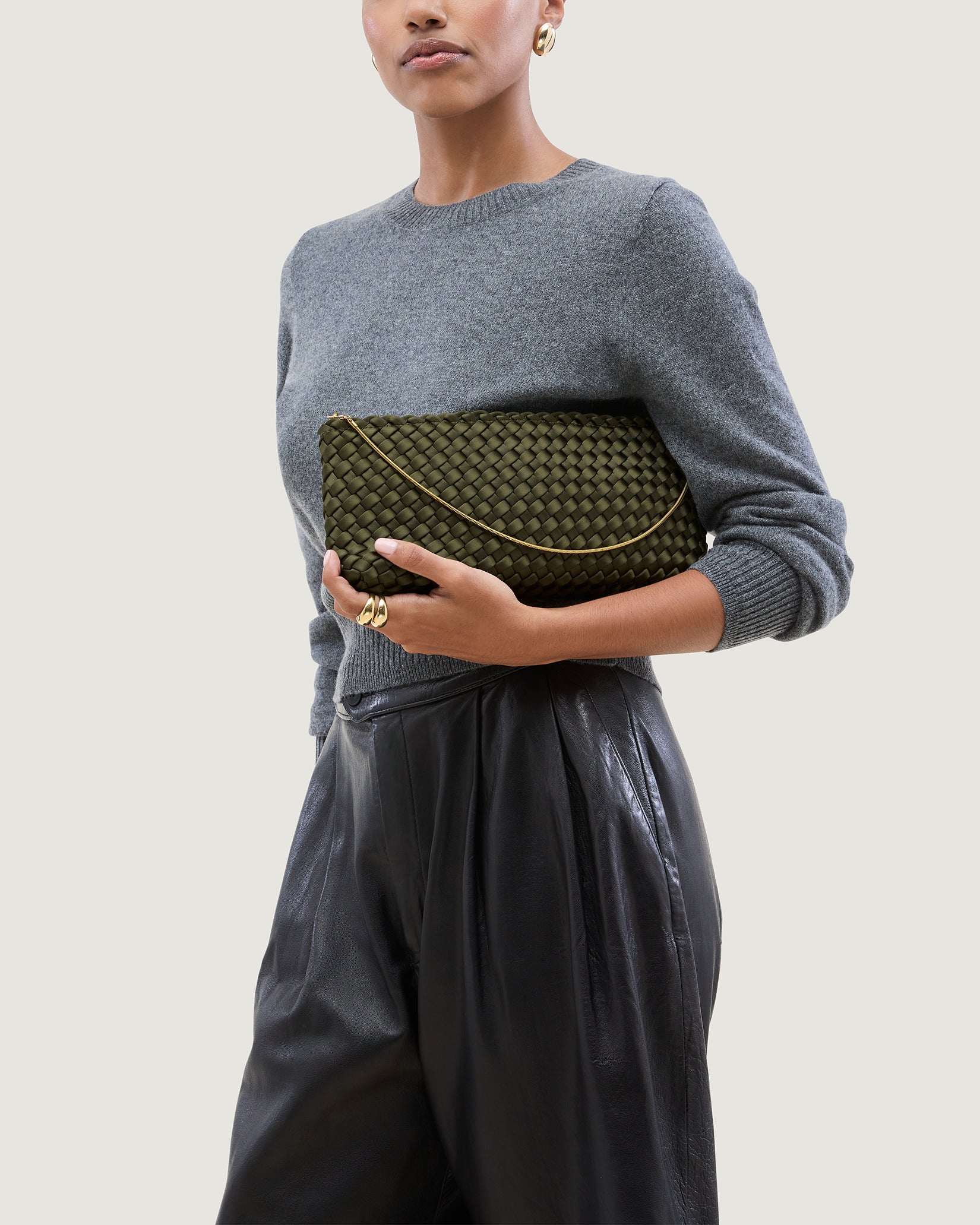 Gala Medium Satin Clutch Bag in Juniper shown on model to illustrate scale and soft silhouette.