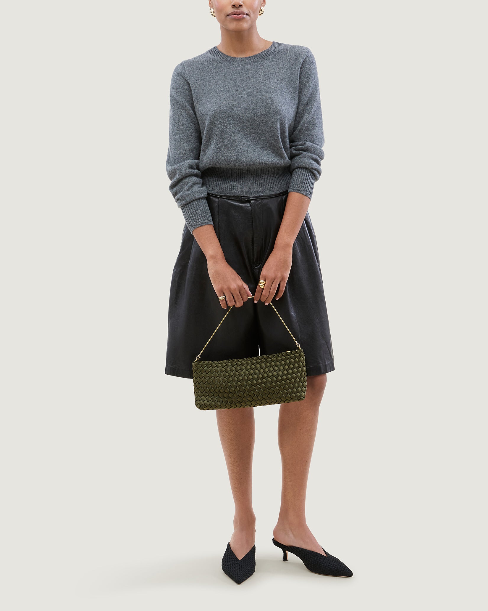 Gala Medium Satin Clutch Bag in Juniper shown on model to illustrate scale and soft silhouette.