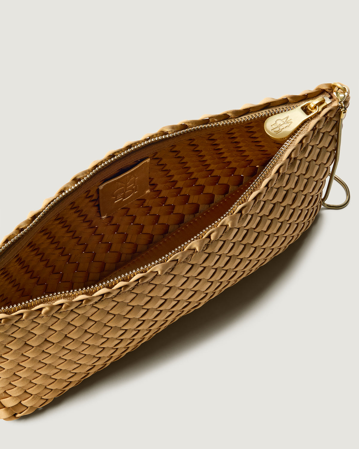 Interior close-up of Gala Clutch in Luce showing its top zip closure.