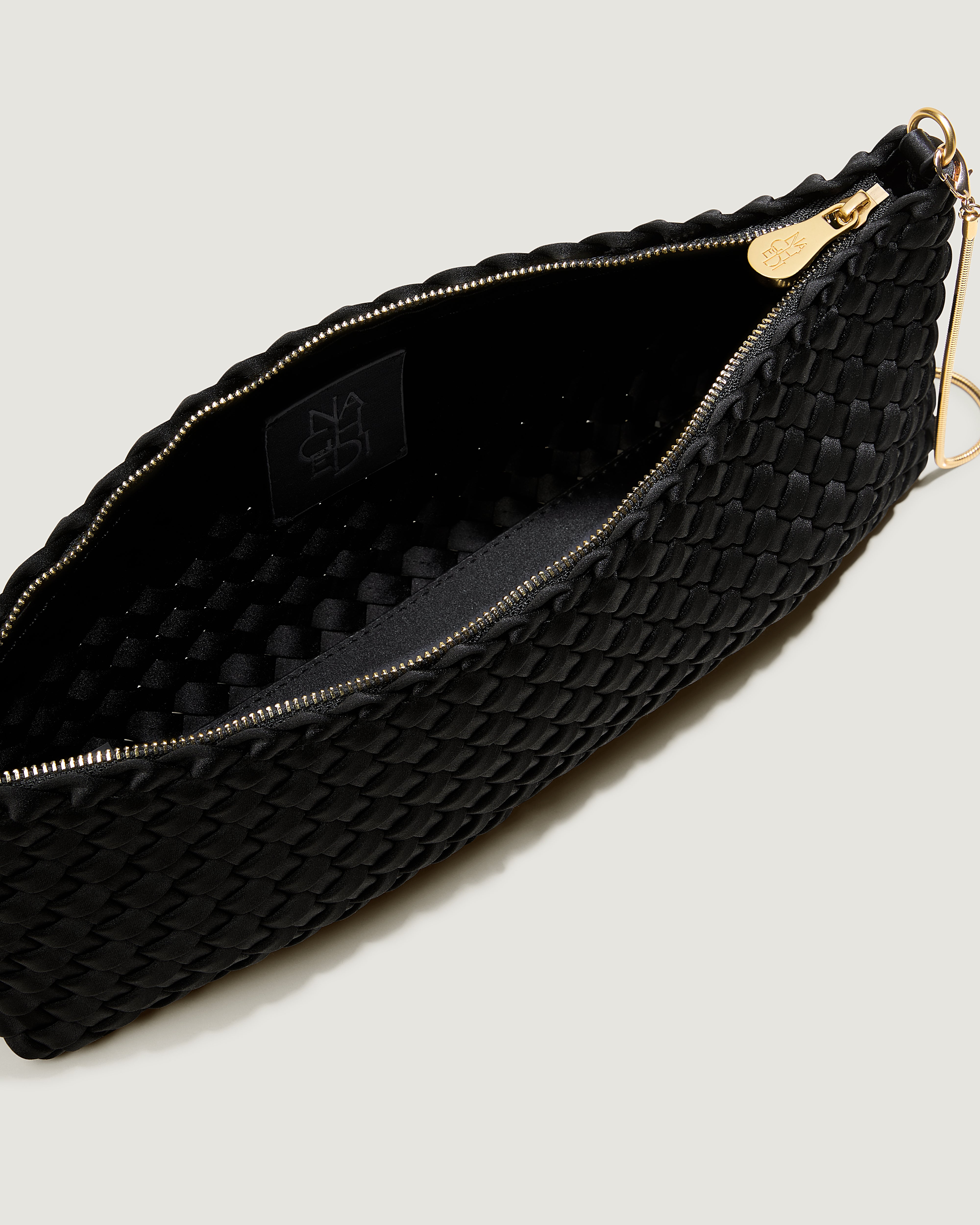 Interior close-up of Gala Clutch in Onyx showing its top zip closure.
