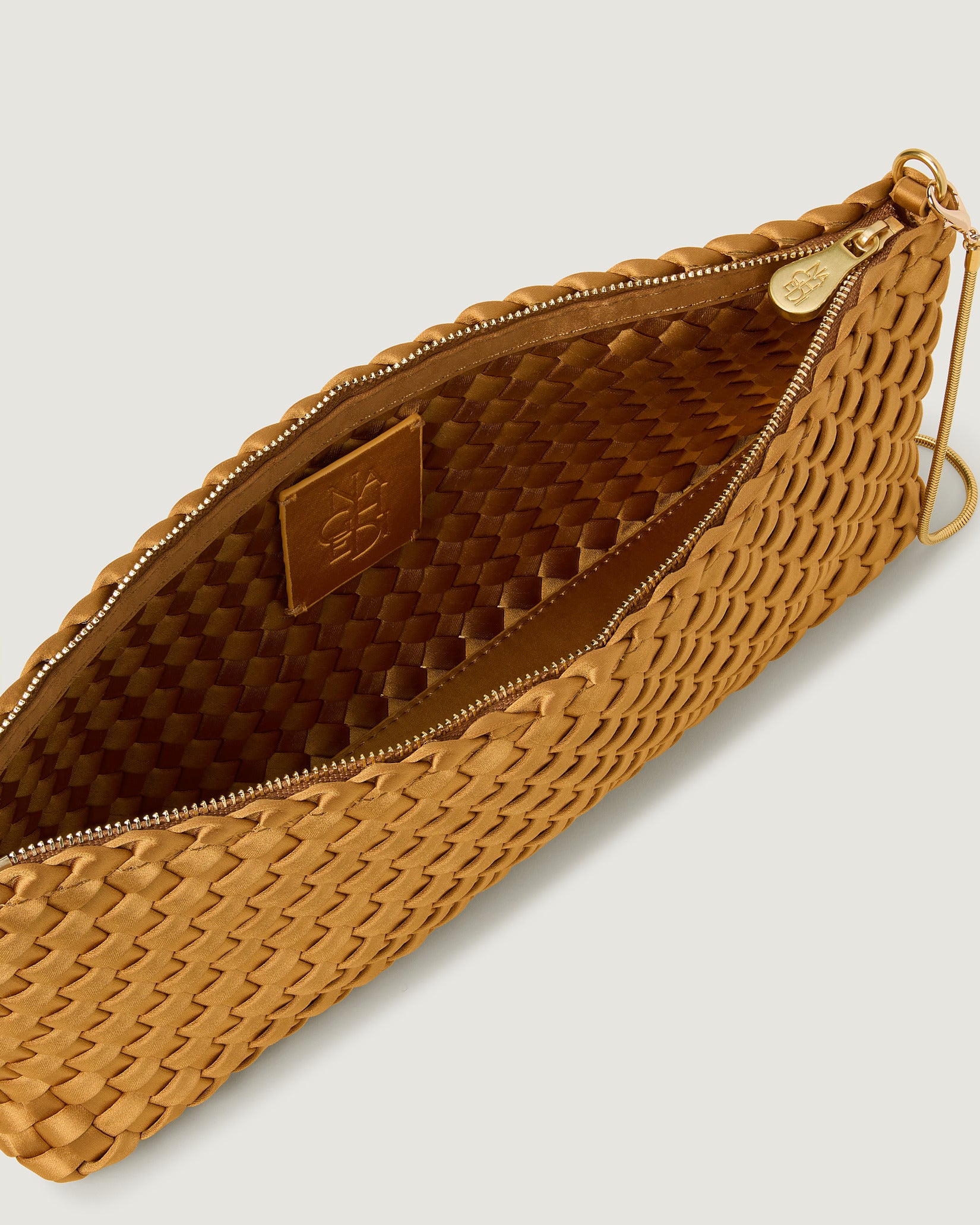 Interior close-up of Gala Medium Satin Clutch Bag in Ore showing its top zip closure.