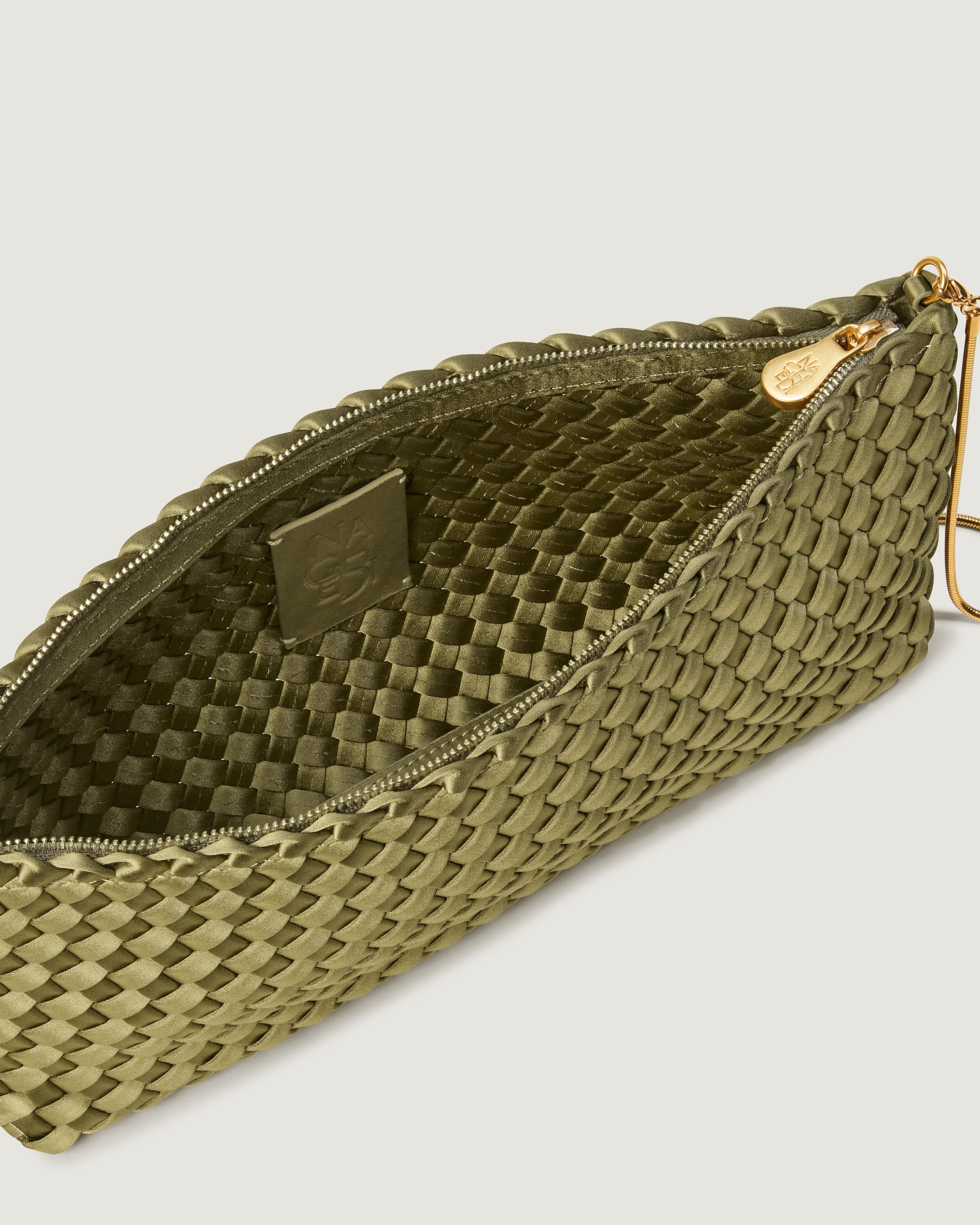 Interior close-up of Gala Clutch in Peridot showing its top zip closure.