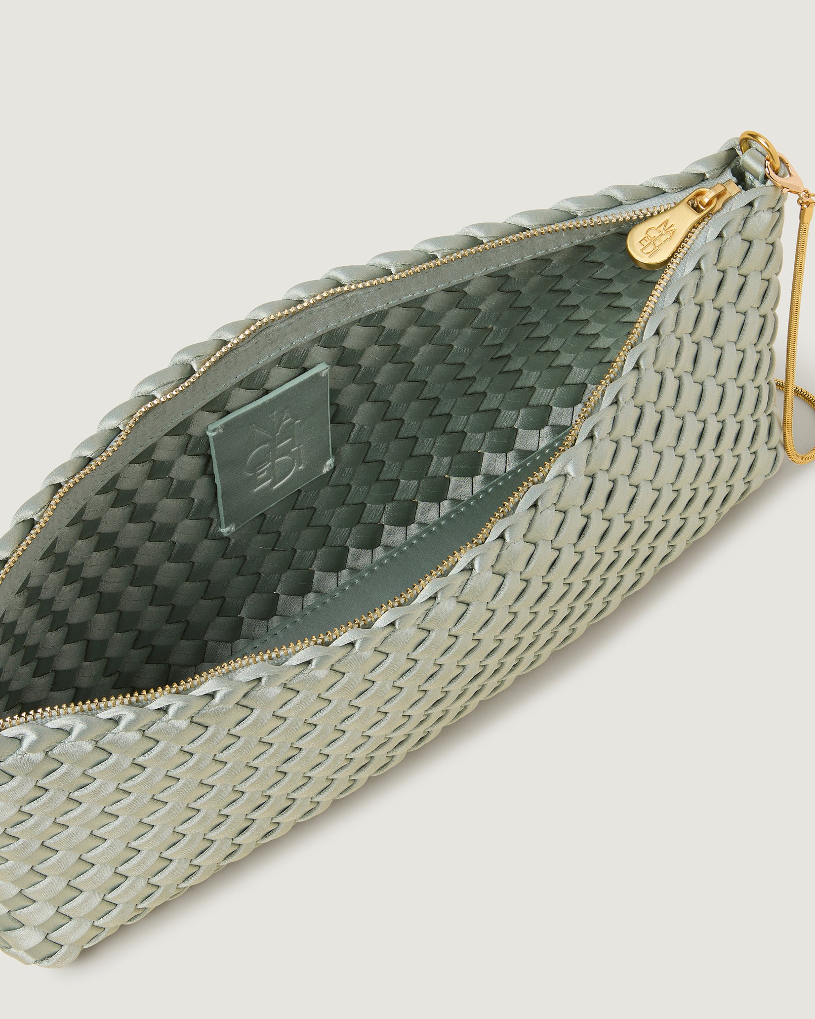 Interior close-up of Gala Medium Satin Clutch Bag in Wintergreen showing its top zip closure.