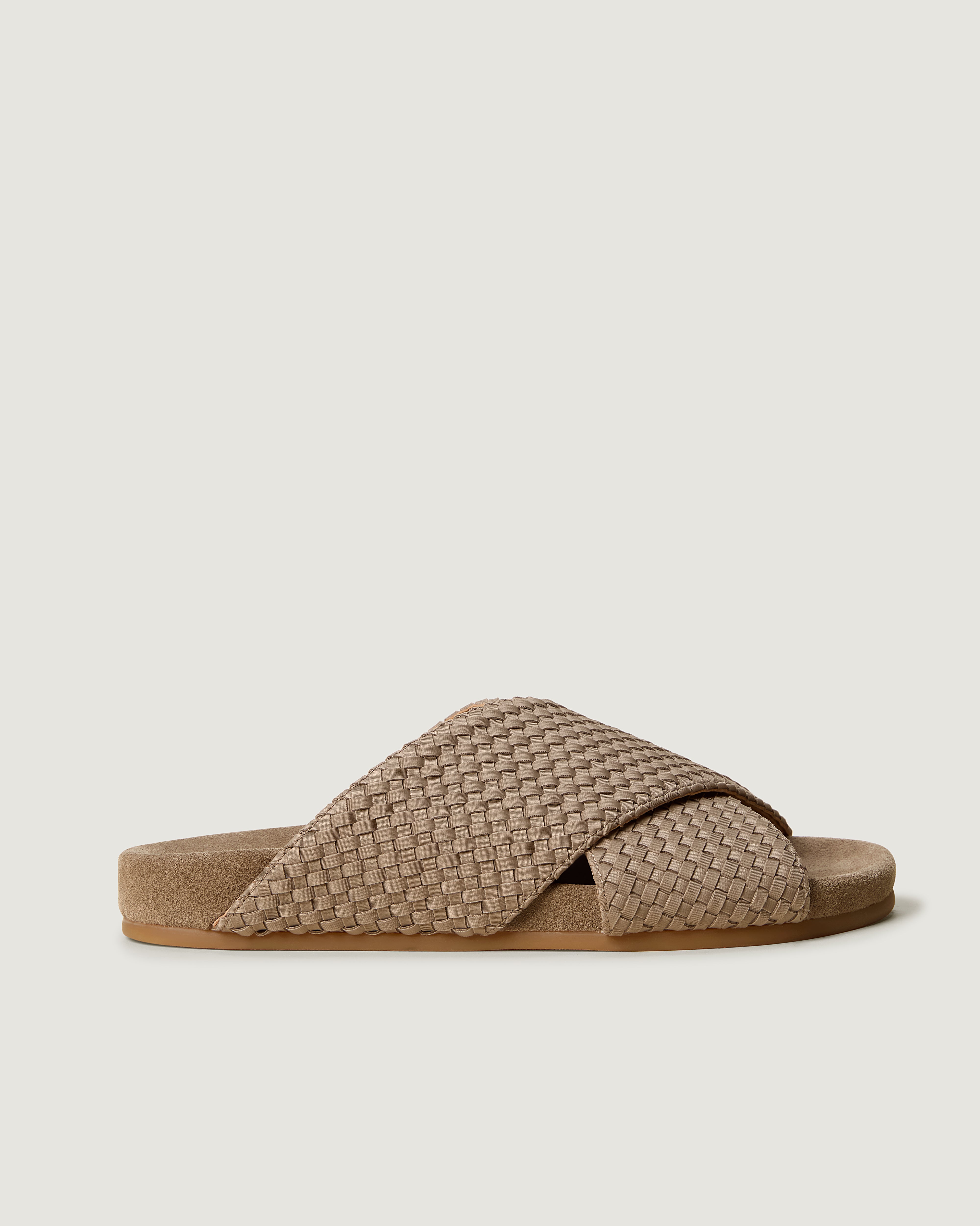 Side view of The Geneva Slide in Cashmere, a taupe tone, featuring an open toe and round silhouette.