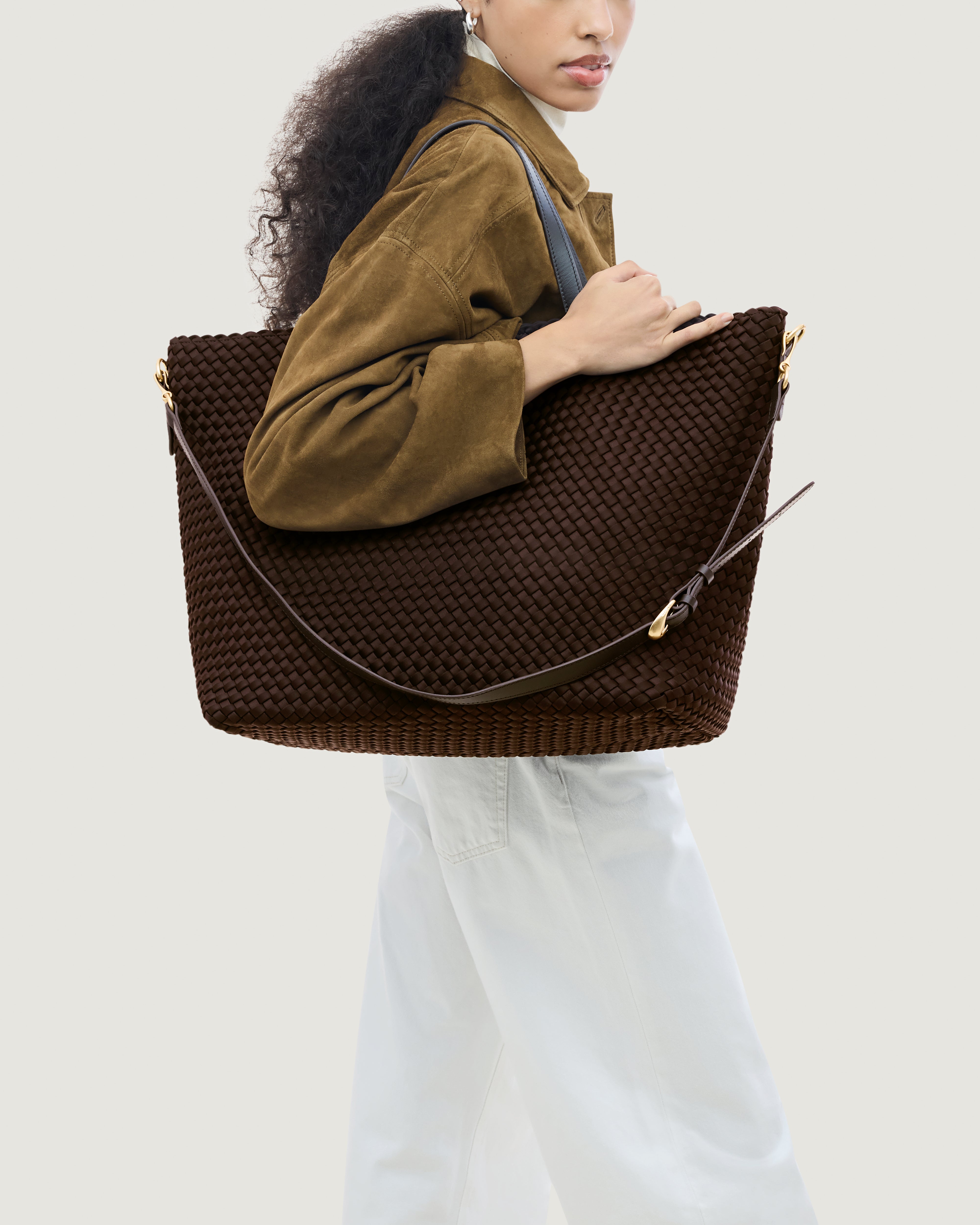 Geneva Weekender in Chocolate shown on model to illustrate scale and soft silhouette.