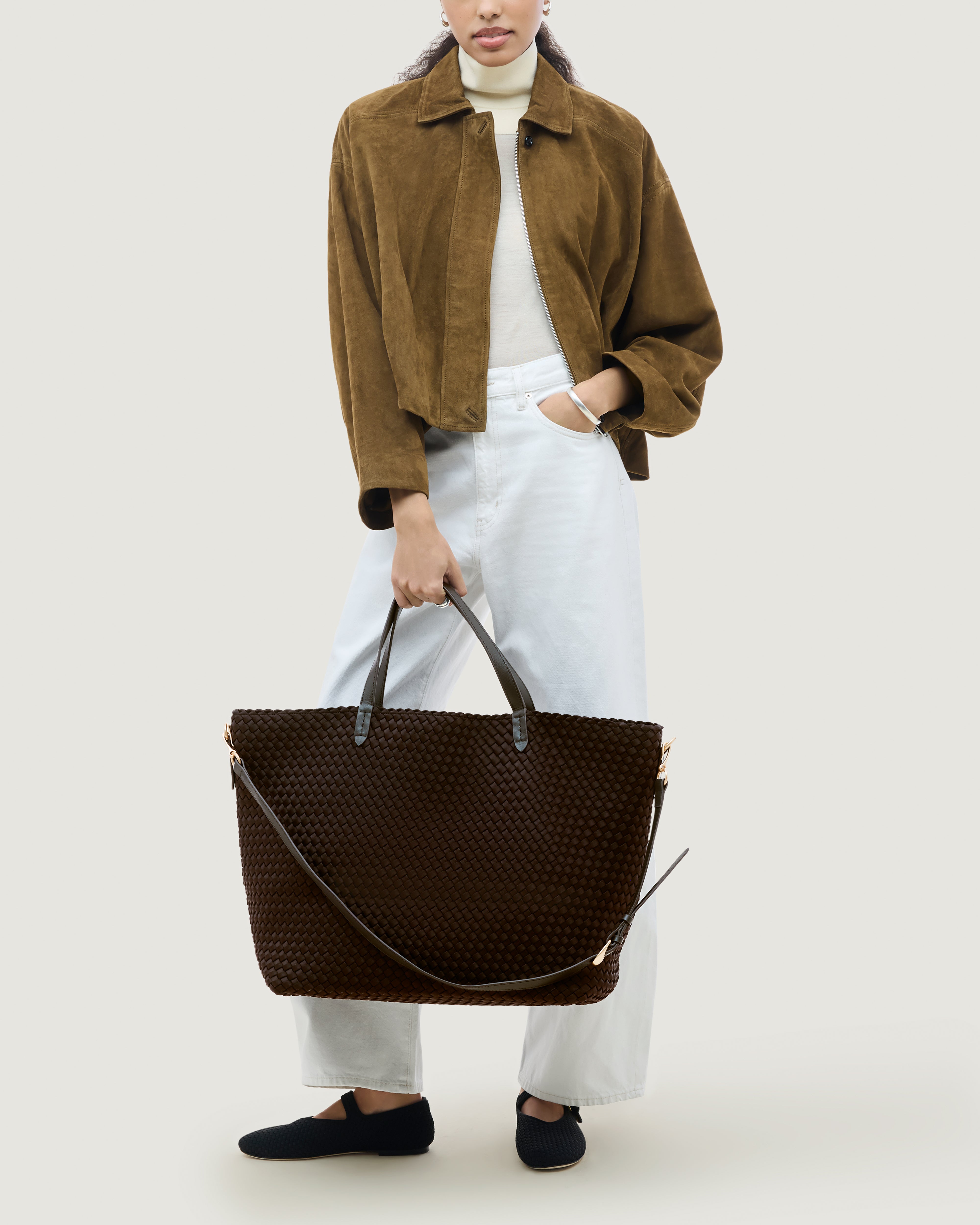 Geneva Weekender in Chocolate shown on model to illustrate scale and soft silhouette.