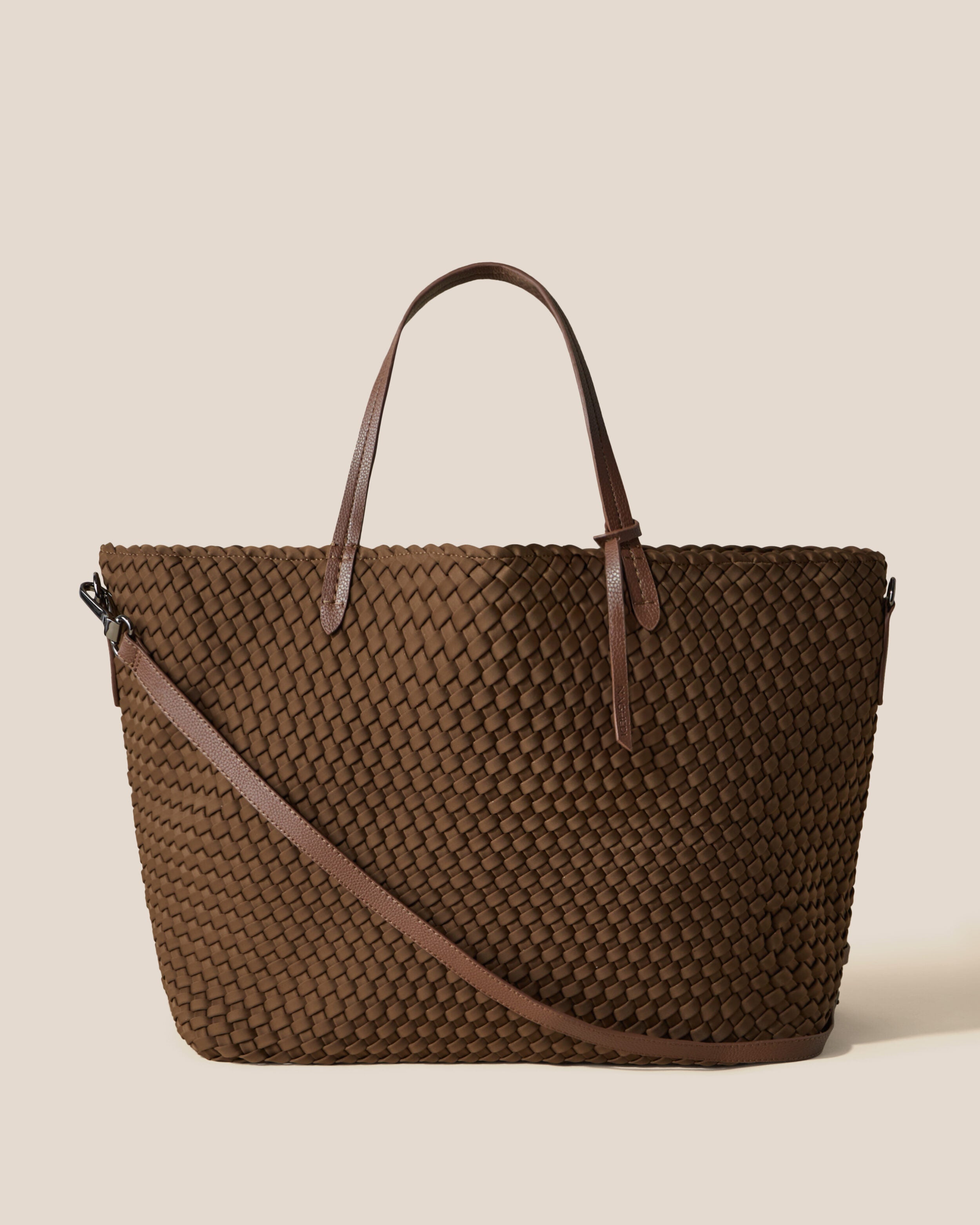 Geneva Weekender in Mink, a brown tone, in handwoven neoprene, featuring a top zip closure, vegan leather handles, and detachable, adjustable vegan leather strap.