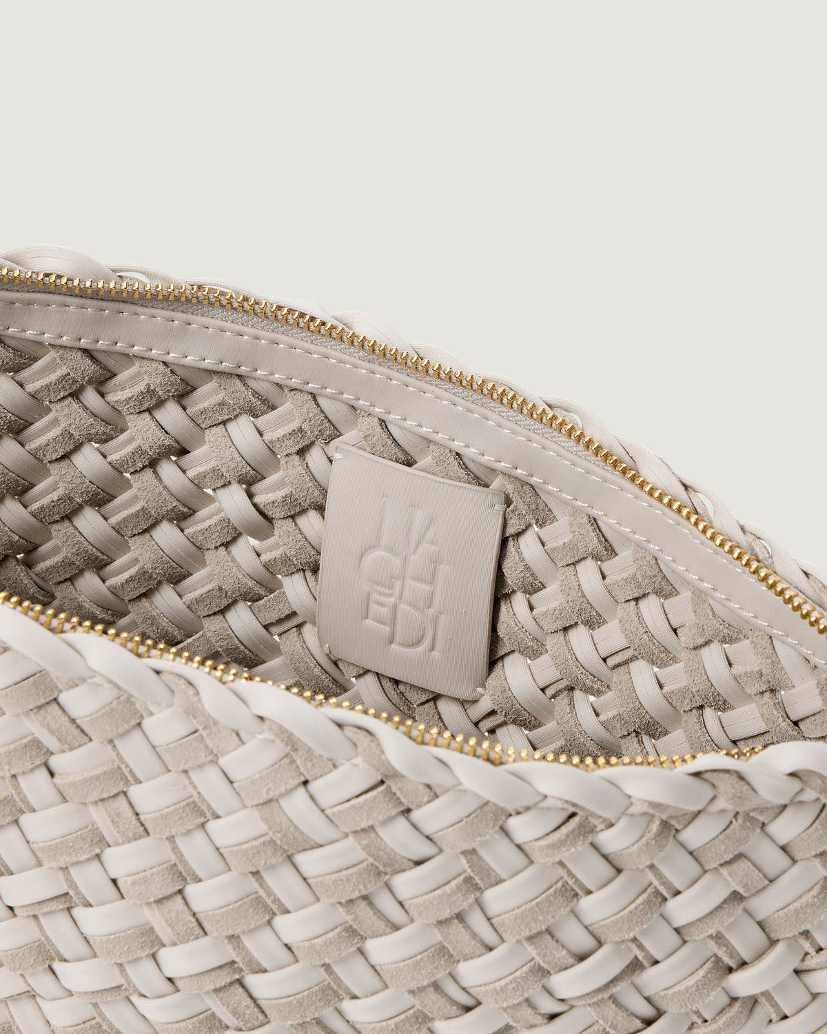 Interior close up of the Gigi Large Clutch in Linen, an ivory tone, showing the zippered closure and unlined interior