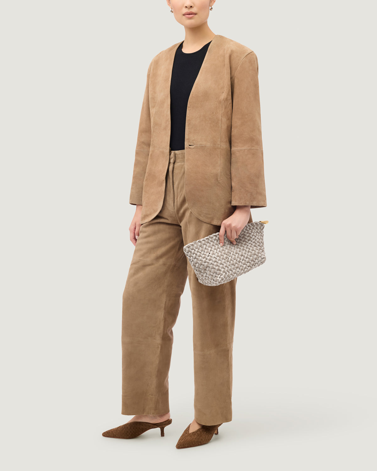Gigi Large Clutch in Linen shown on model to illustrate size and soft silhouette