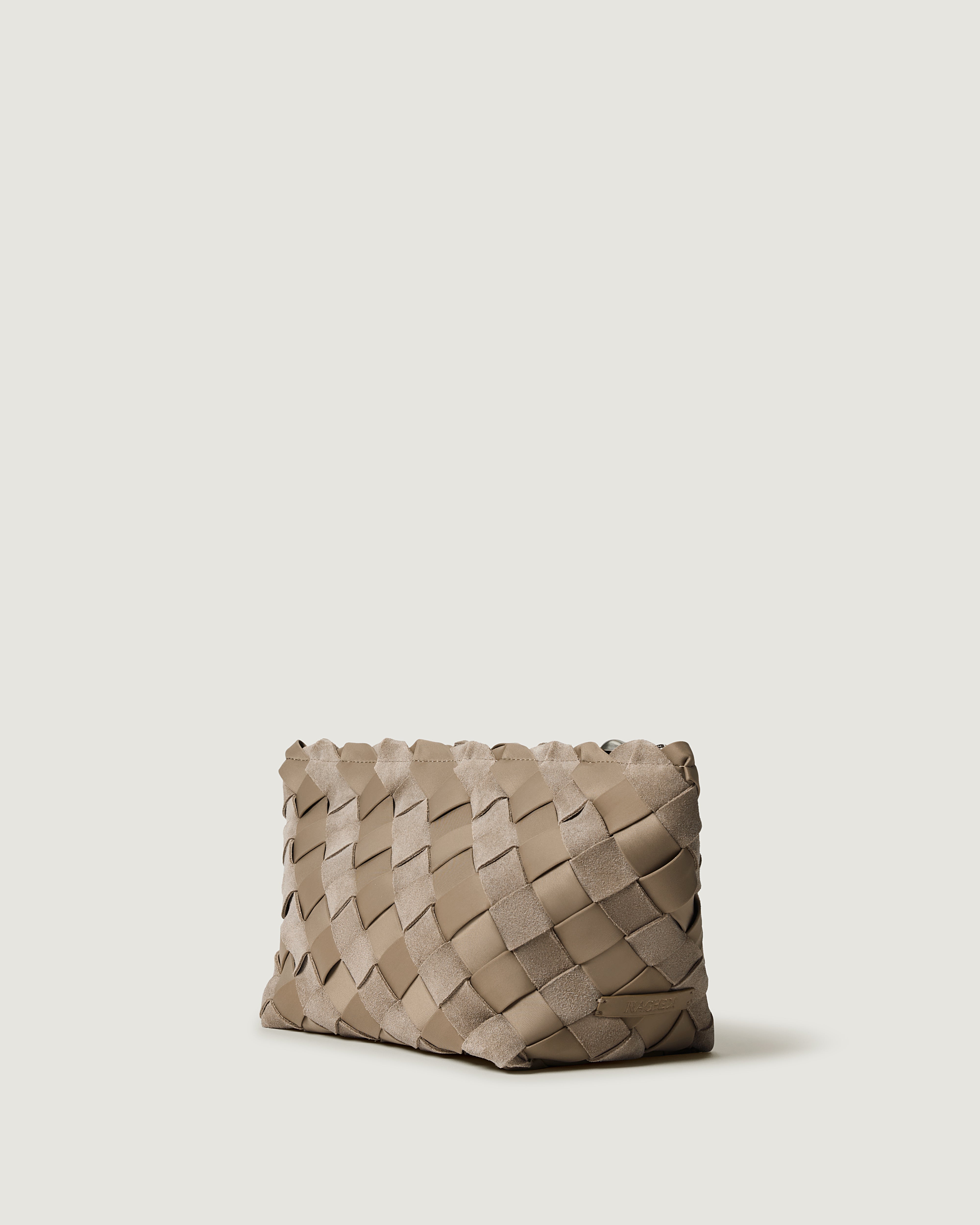 A handwoven suede and neoprene clutch bag in a taupe-beige color, featuring a basketweave pattern and a top zipper closure.