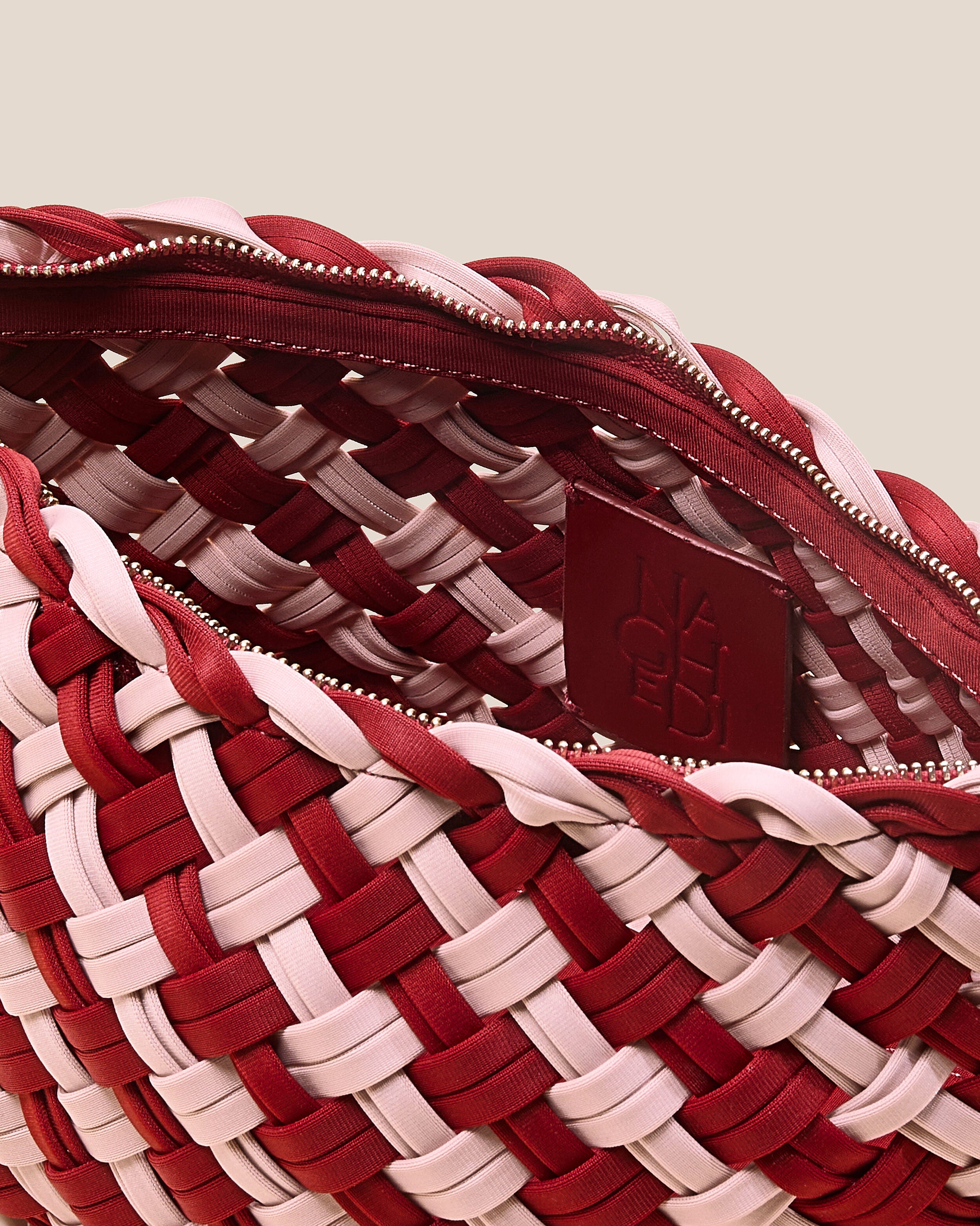 Interior close-up of Gigi Clutch in Lychee showing its top zip closure, and unlined interior.