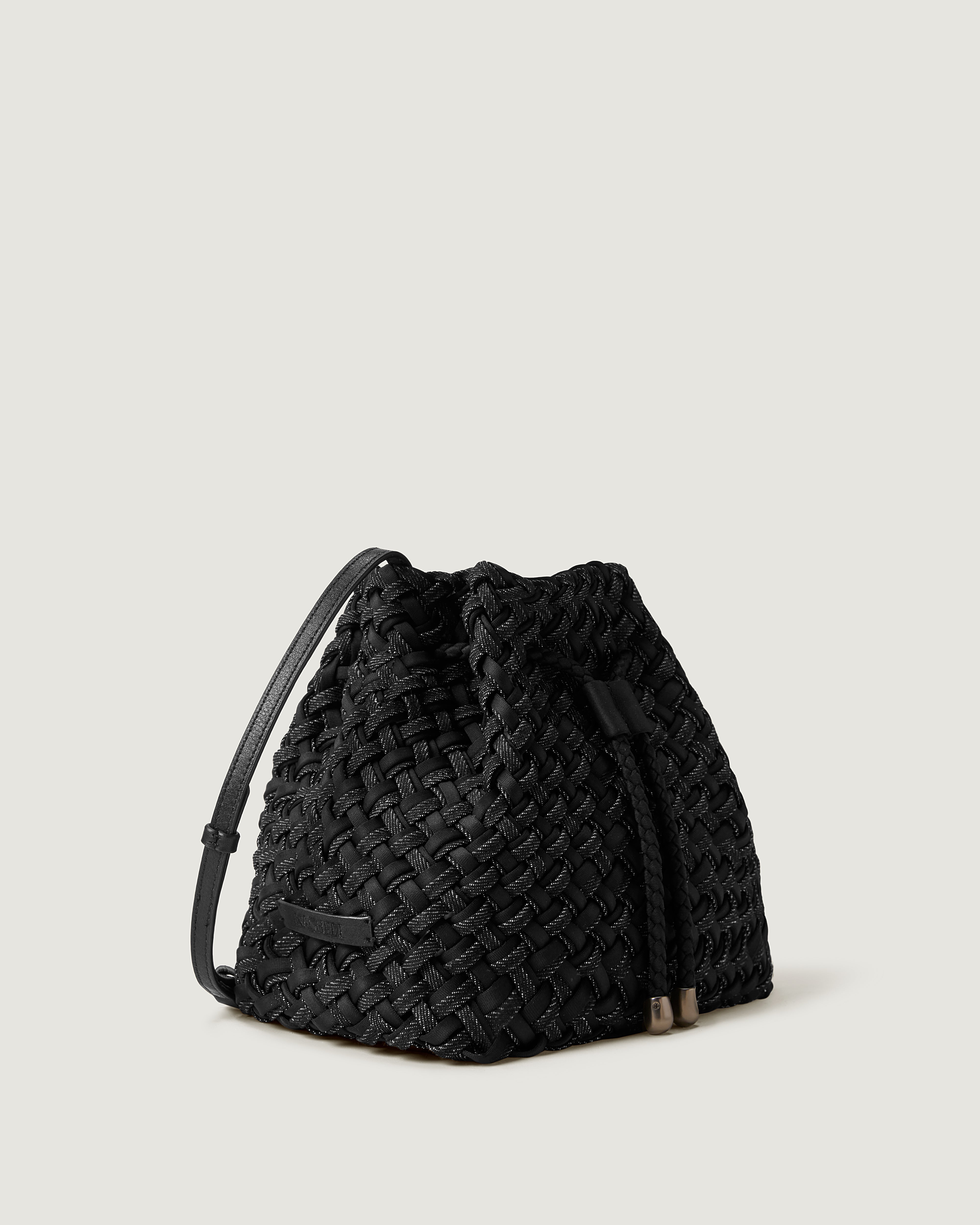 Gramercy Bucket in Jet shown from a side angle, highlighting its handwoven neoprene construction and drawstring closure.