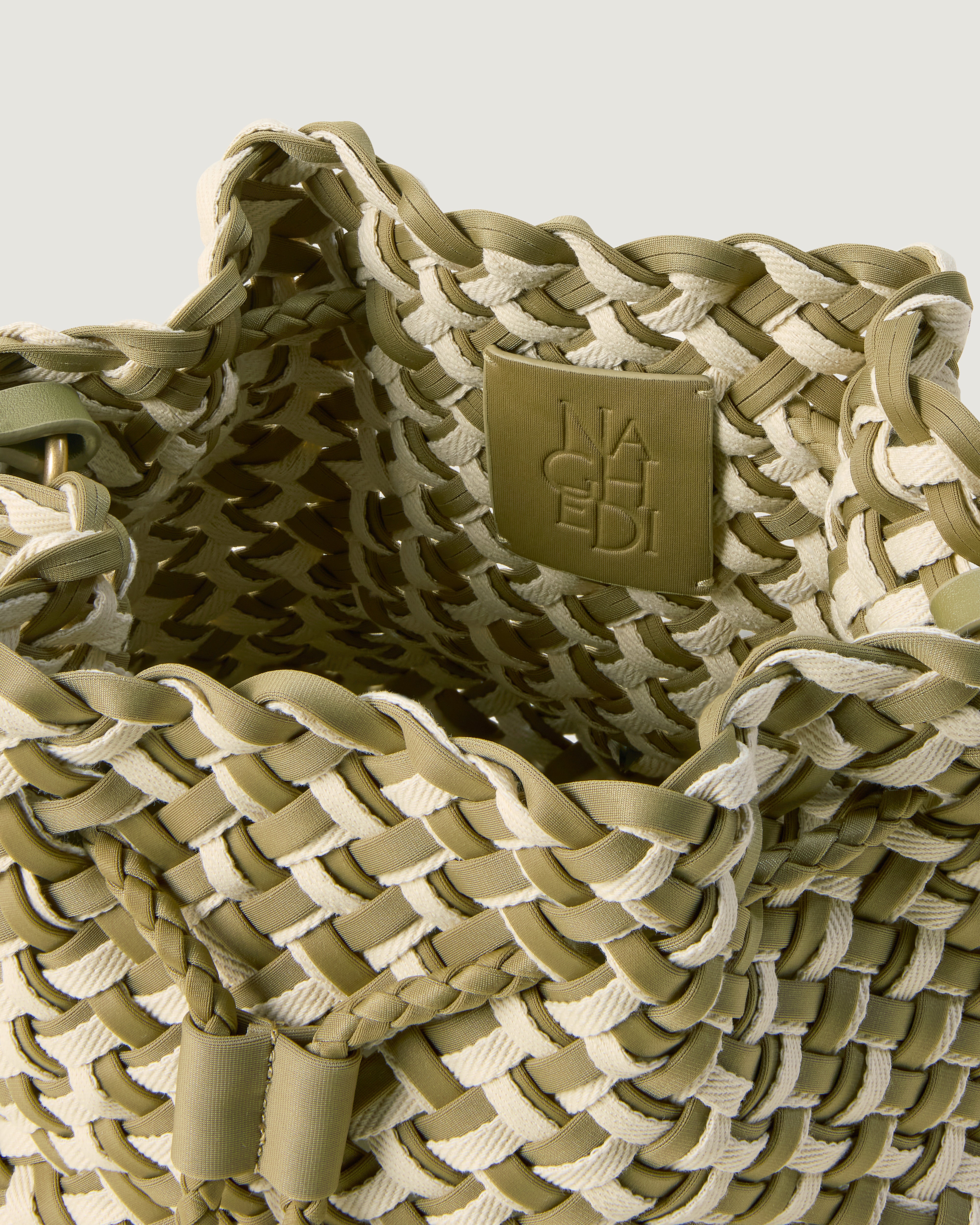 Interior close-up of Gramercy Bucket in Oletta showing its drawstring closure, and unlined interior.