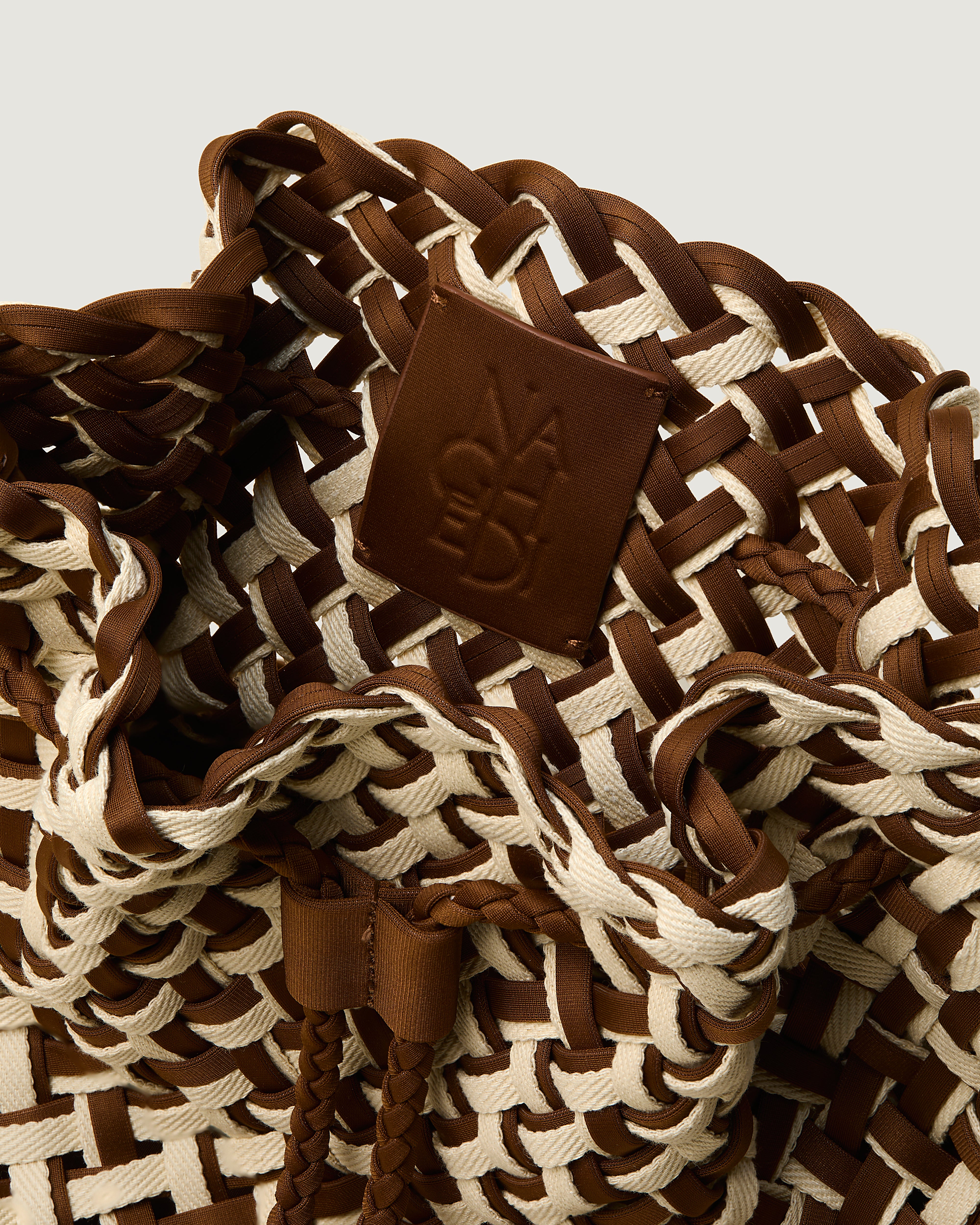 Interior close-up of Gramercy Bucket in Carmel showing its drawstring closure, and unlined interior.