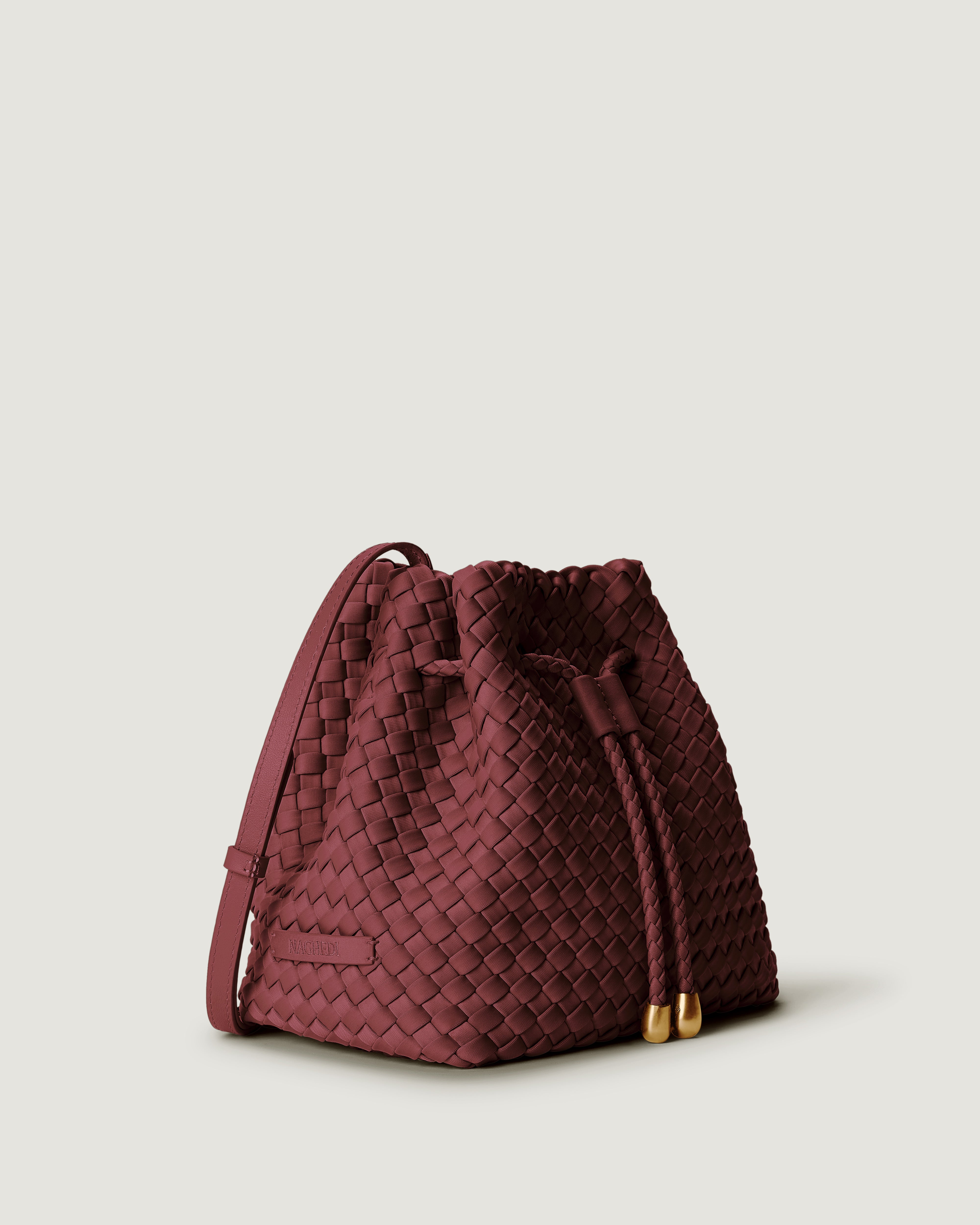 Gramercy Bucket in Bordeaux shown from a side angle, highlighting its handwoven neoprene construction and drawstring closure.