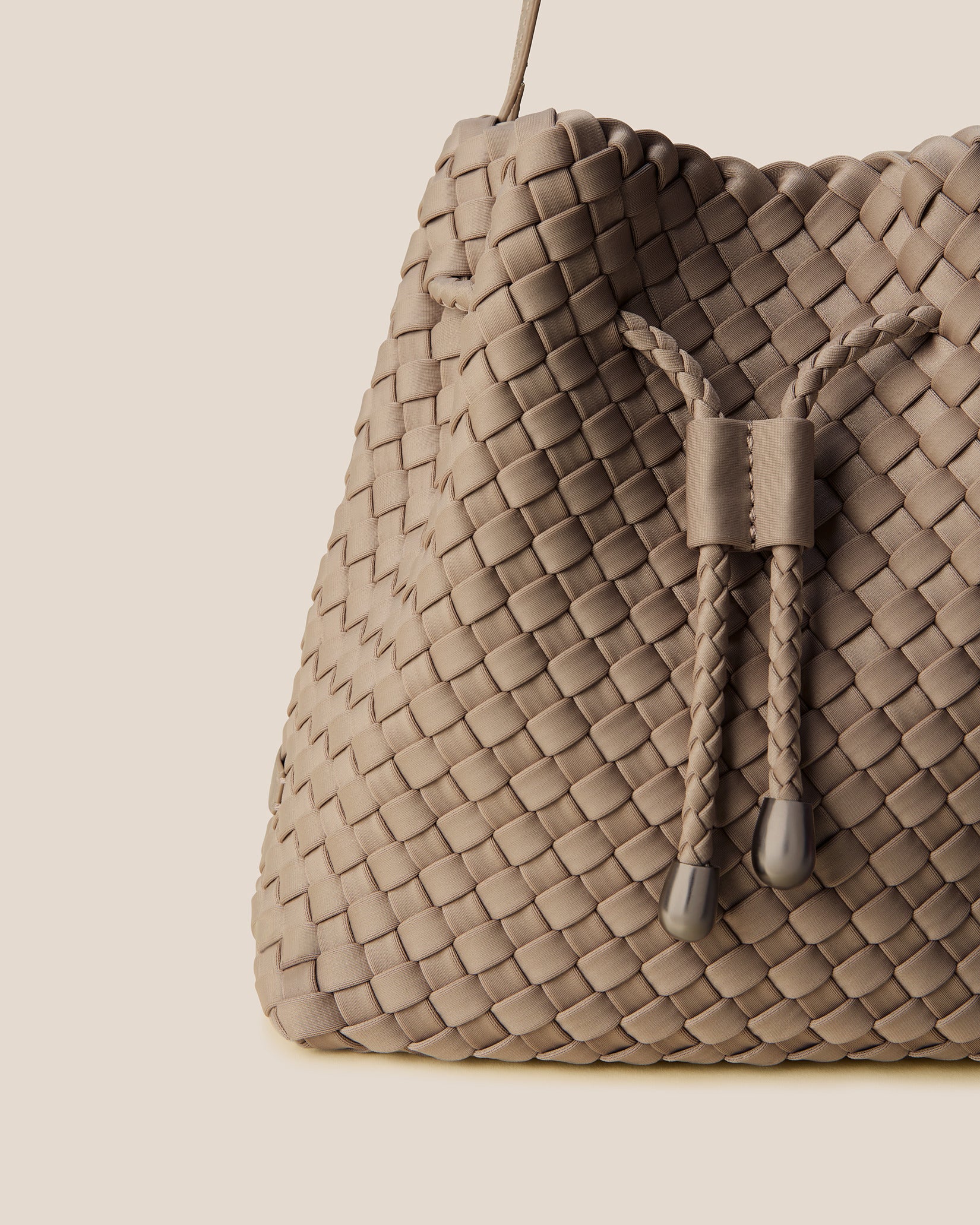 Close-up of handwoven detailing on Gramercy Medium Bucket Bag in Cashmere.